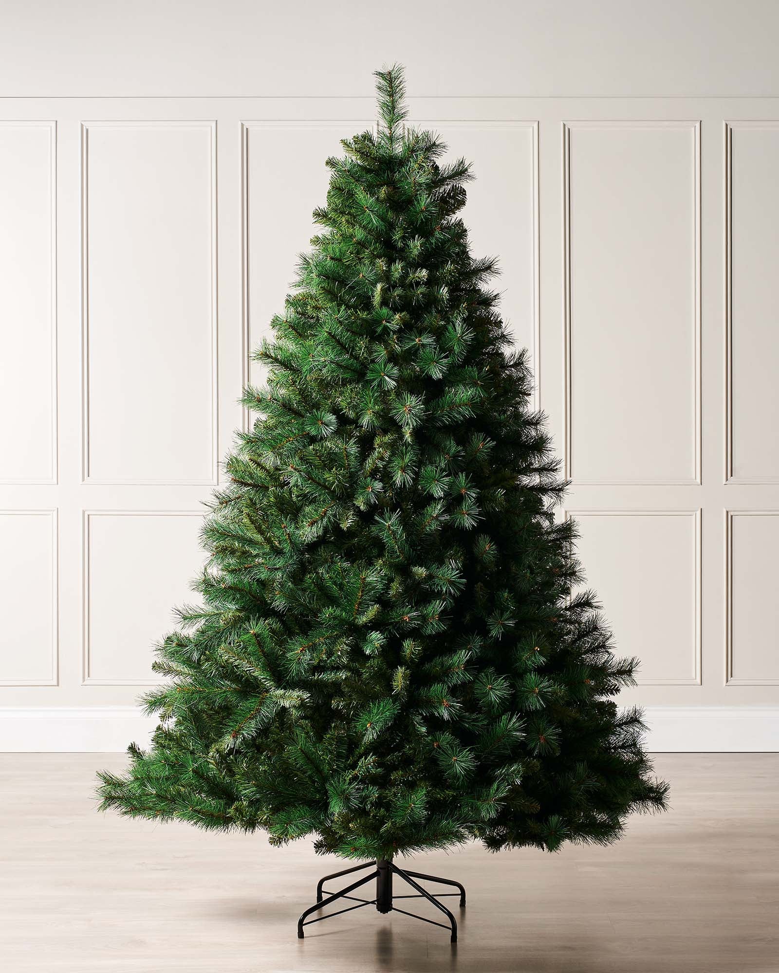 Full-bodied Victorian Pine artificial Christmas tree with dense green needles and a sturdy metal stand, showcasing a realistic and classic design that brings timeless elegance and festive charm to any indoor space.