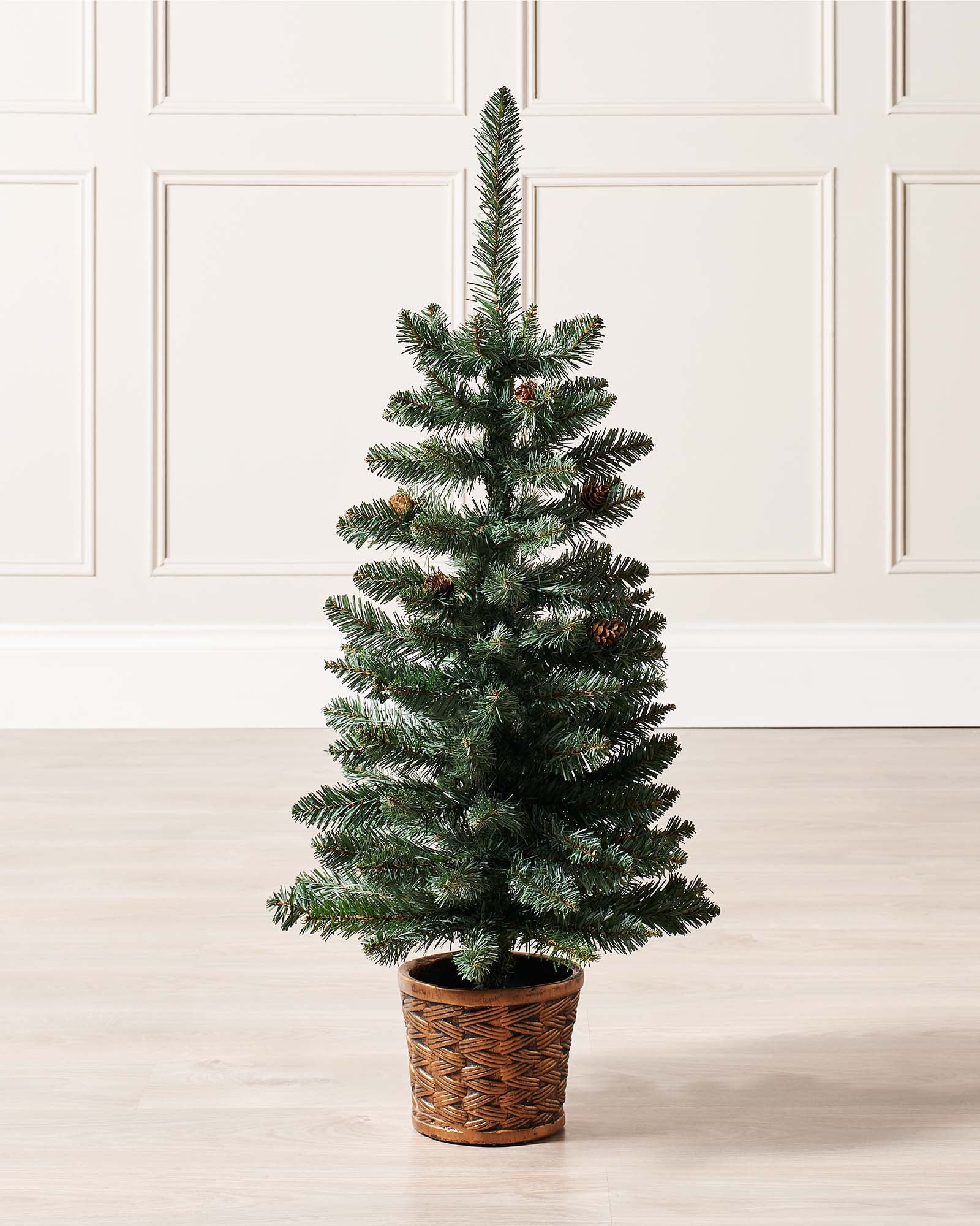 3-foot tall potted Crawford Blue Pine Christmas tree with 102 PVC tips, decorated with rustic pinecones, displayed indoors in a decorative pot