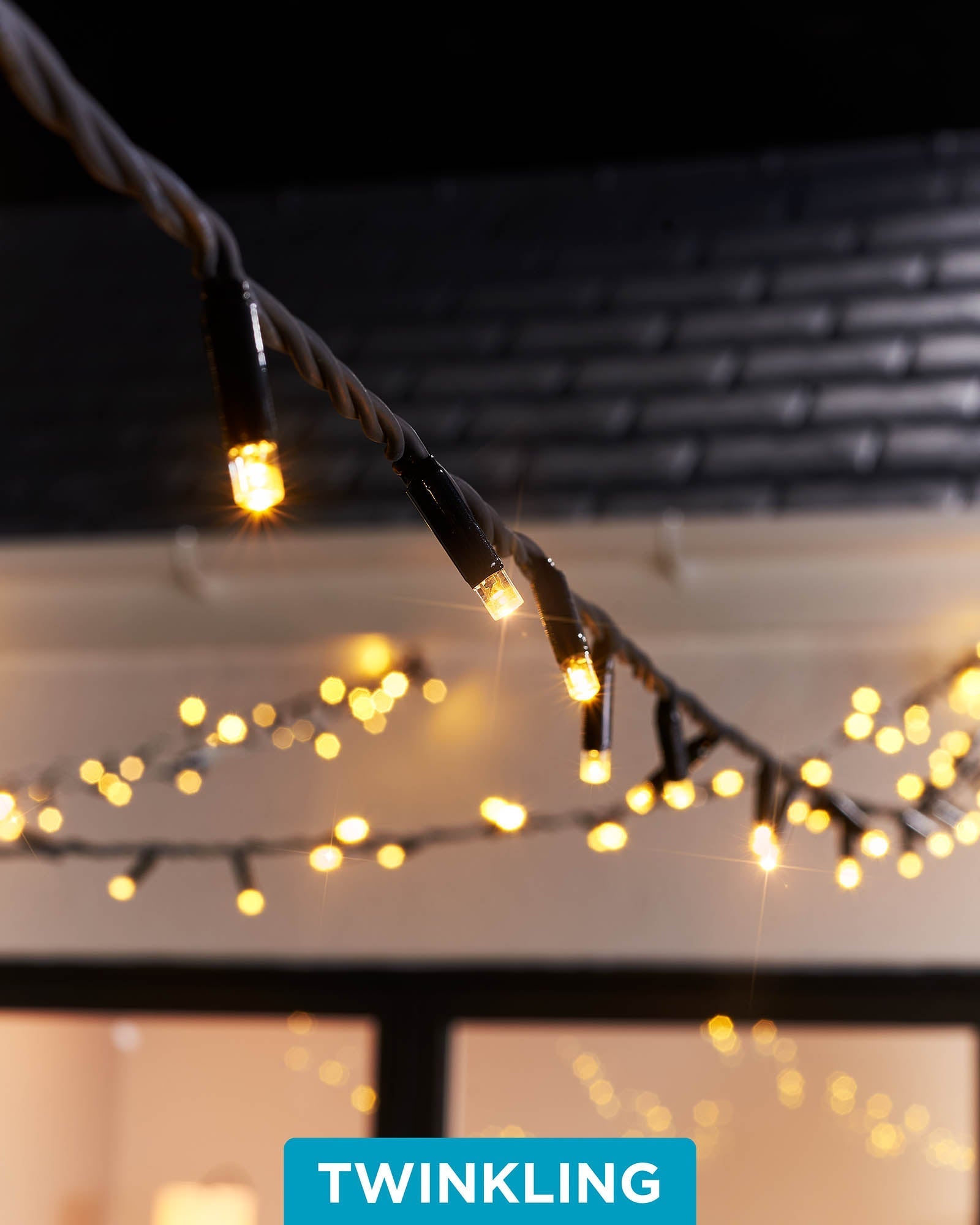 Close-up of warm white LED Christmas string lights with a focus on the twinkle or flashing feature, displayed against a blurred background of similar lights creating a cozy, festive atmosphere.