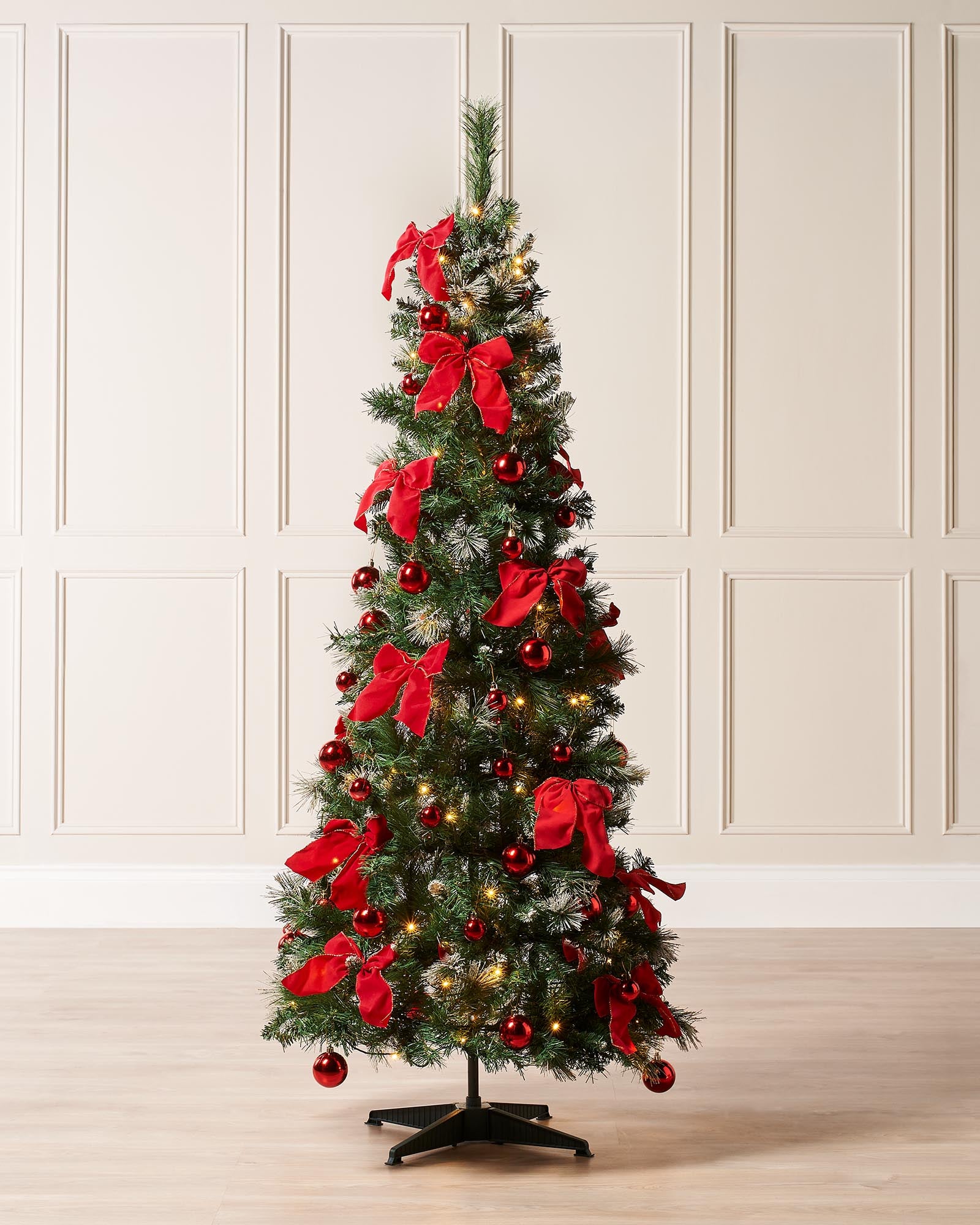 6-foot pre-lit pop-up decorated Christmas tree with 476 PVC tips, warm white LED lights, and red baubles and bows, placed indoors with a 3-meter lead wire.