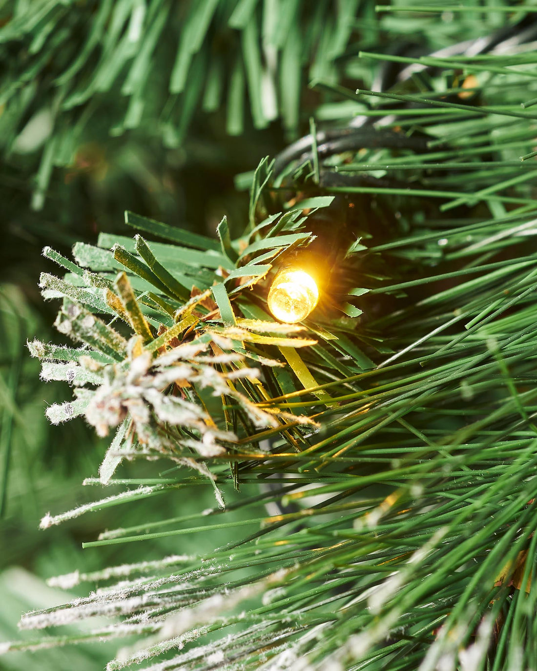 6-foot pre-lit pop-up decorated Christmas tree with 476 PVC tips, warm white LED lights, and red baubles and bows, placed indoors with a 3-meter lead wire.
