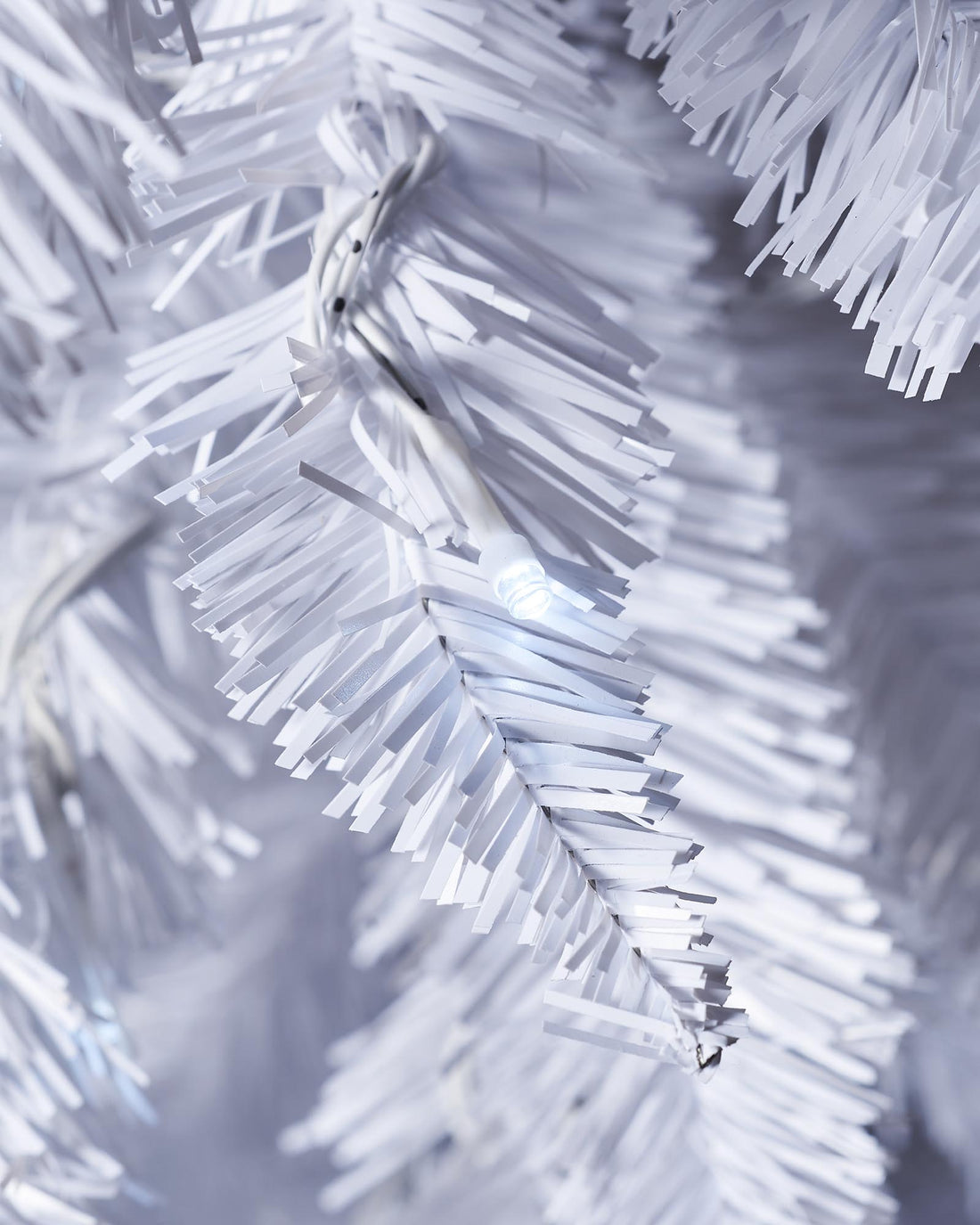 A pre-lit white pencil Christmas tree with slender branches, featuring 400 mixed PE and PVC tips and 180 bright white LED lights. The tree stands upright with a 64 cm diameter, blending modern elegance with festive charm.