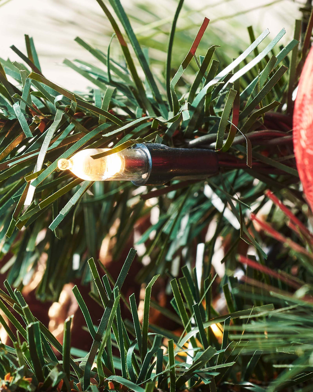 4-foot pre-lit potted Christmas tree with 140 PVC tips, warm white LED lights, red and silver baubles, pinecones, and berries, set against a white background.