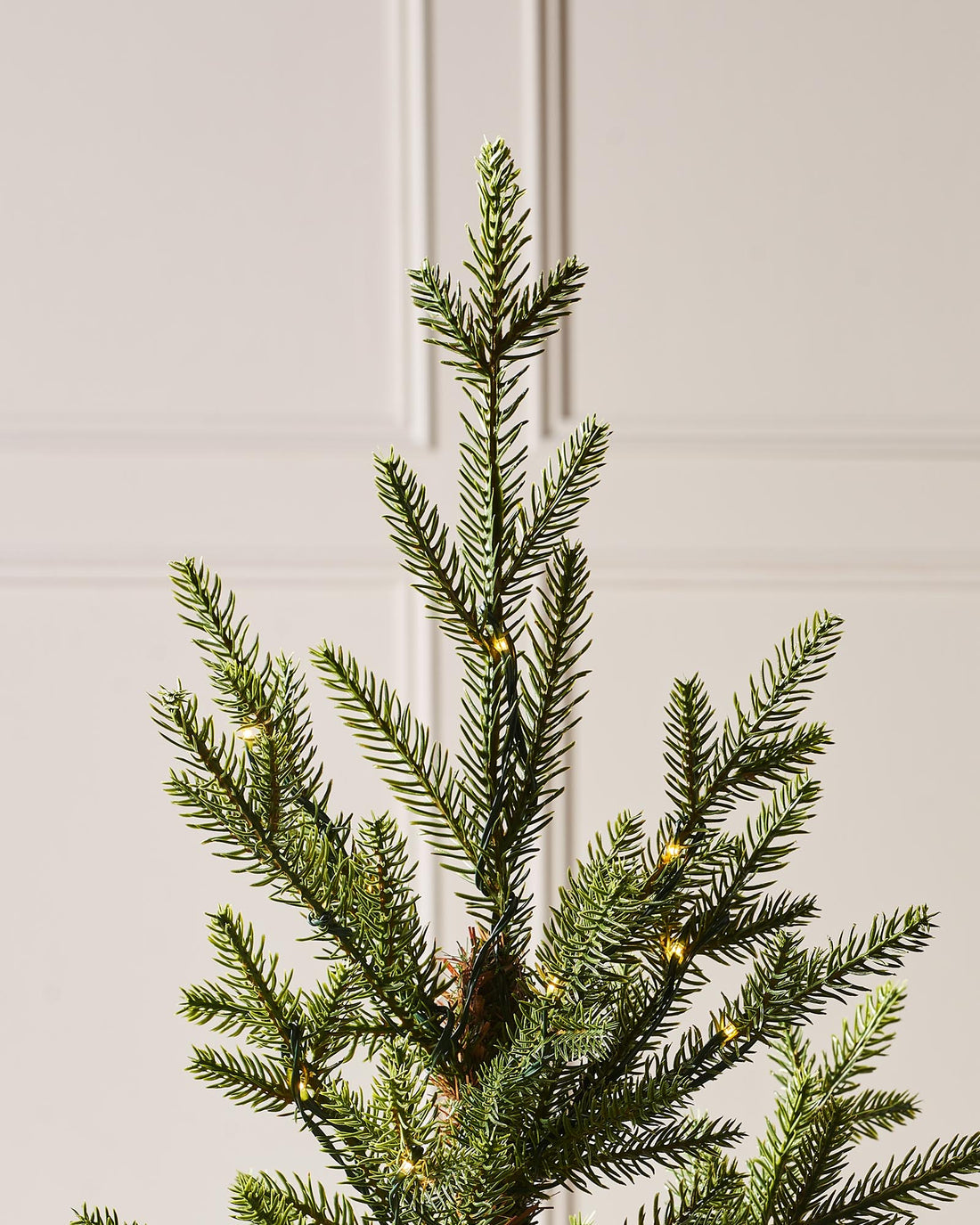 3-foot Douglas Fir potted Christmas tree with realistic PE tips, adorned with delicate copper wire micro LED lights, standing indoors in a black pot.