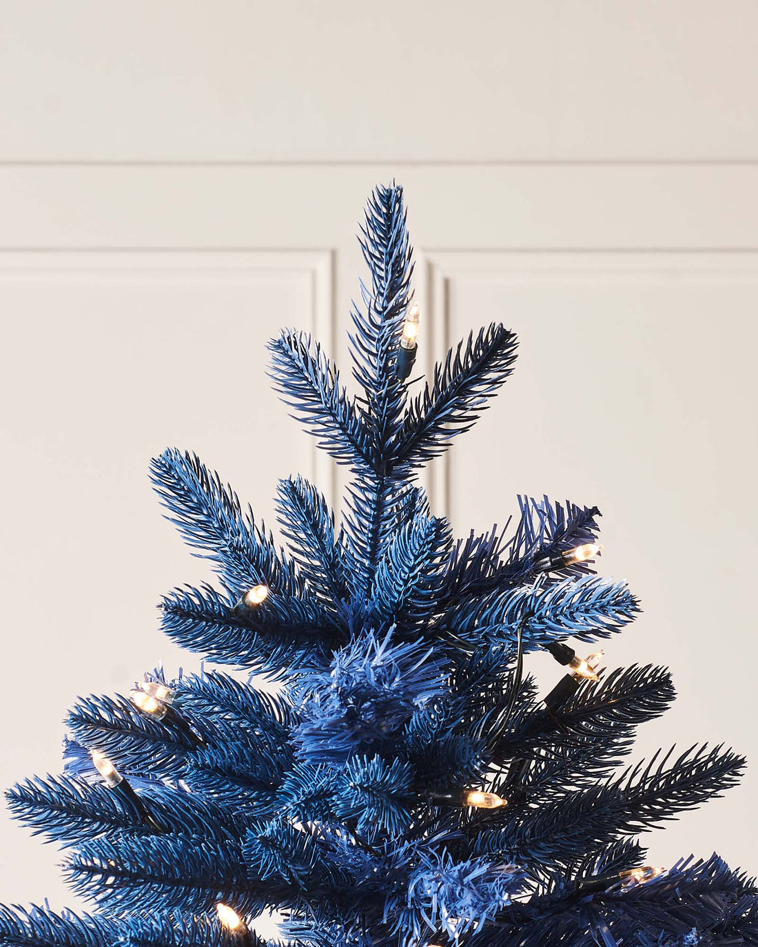 A 4 ft pre-lit potted pine and Royal Fir Christmas tree duo, both with lush green foliage. One stands in a decorative pot with dual warm white and multicolour LED lights for indoor or outdoor use; the other features multi-function warm white LED lights on a metal stand, displayed against a white background.