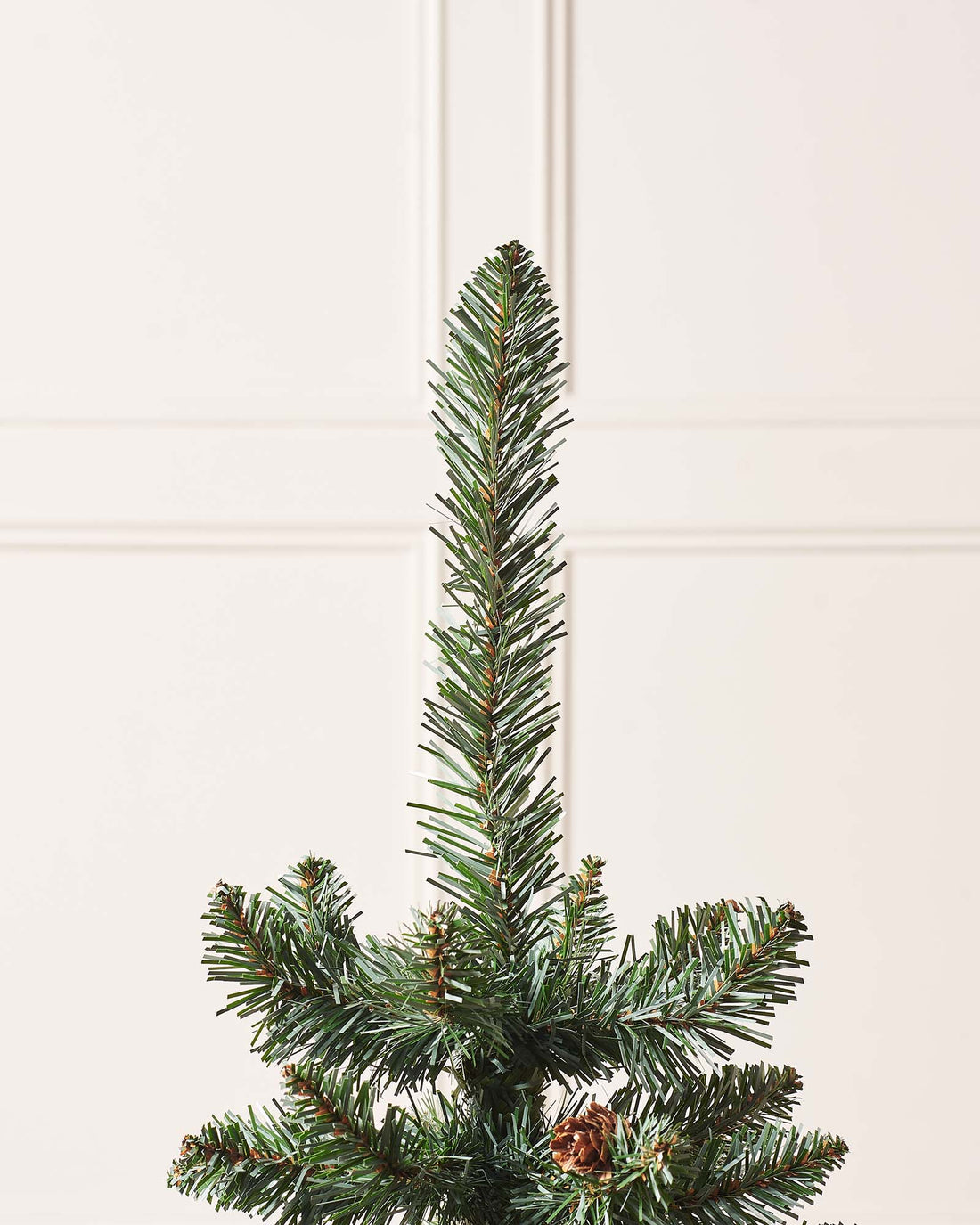 3-foot tall potted Crawford Blue Pine Christmas tree with 102 PVC tips, decorated with rustic pinecones, displayed indoors in a decorative pot