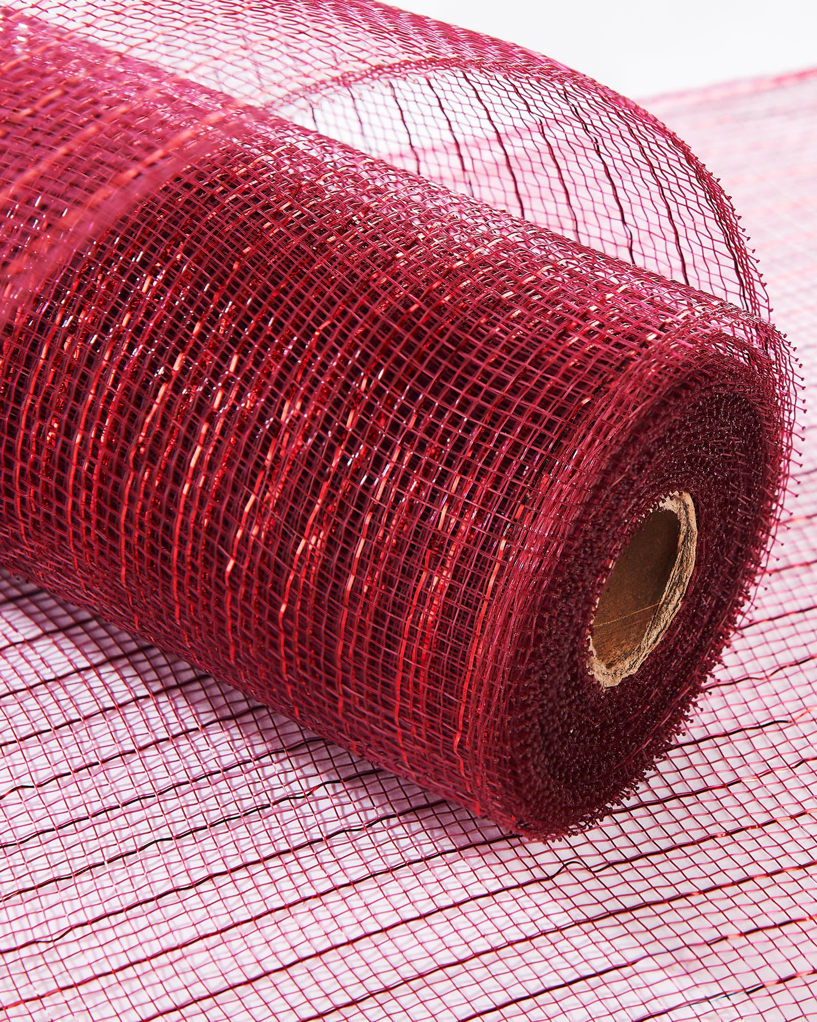 Burgundy mesh with red foil ribbon wrapped around a Christmas tree.