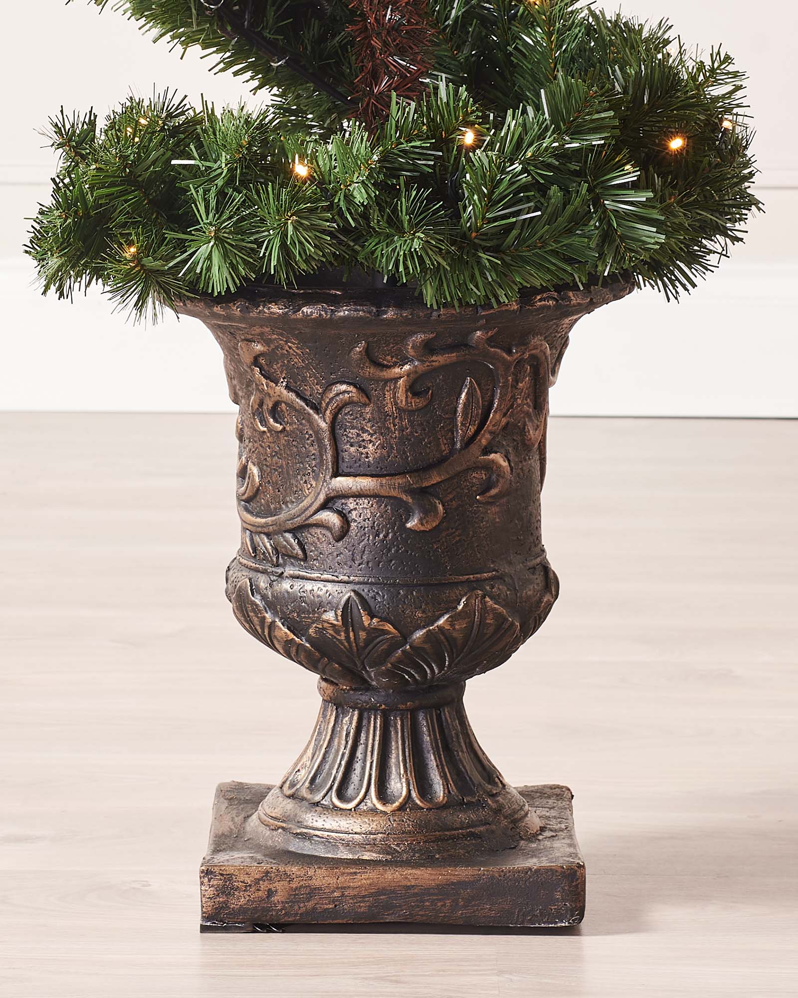 6-foot pre-lit spiral potted Christmas tree with a slender 41 cm diameter, featuring 400 PVC tips shaped in a modern spiral design. Decorated with warm white LED lights and red berries, displayed indoors in a stylish pot.