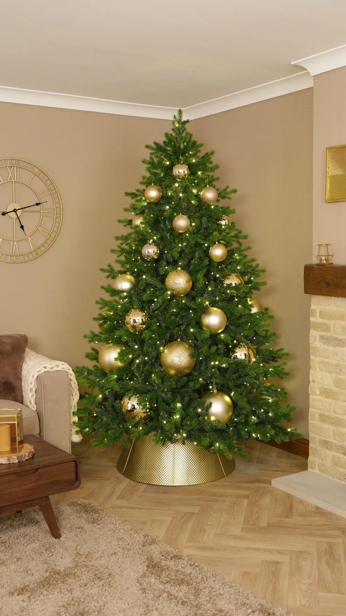 Layer Smaller Gold Baubles Throughout the Tree