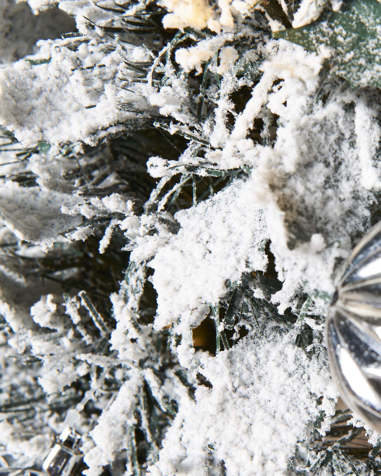 6 ft pre-lit decorated pop-up snow flocked Christmas tree with 150 warm white LEDs, white and silver baubles, and a snow-flocked finish—easy setup, creating a cozy indoor winter wonderland centerpiece.