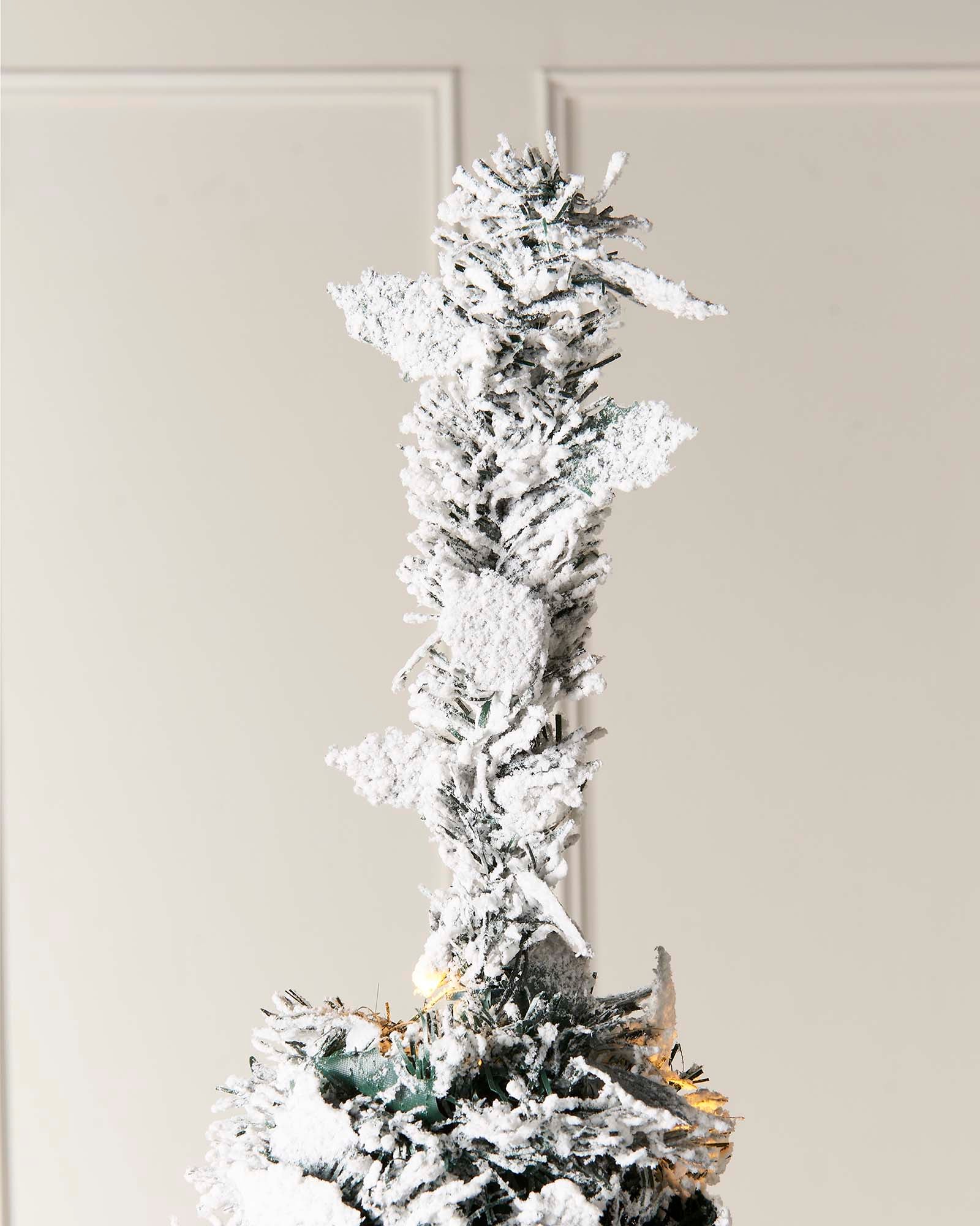 6 ft pre-lit decorated pop-up snow flocked Christmas tree with 150 warm white LEDs, white and silver baubles, and a snow-flocked finish—easy setup, creating a cozy indoor winter wonderland centerpiece.