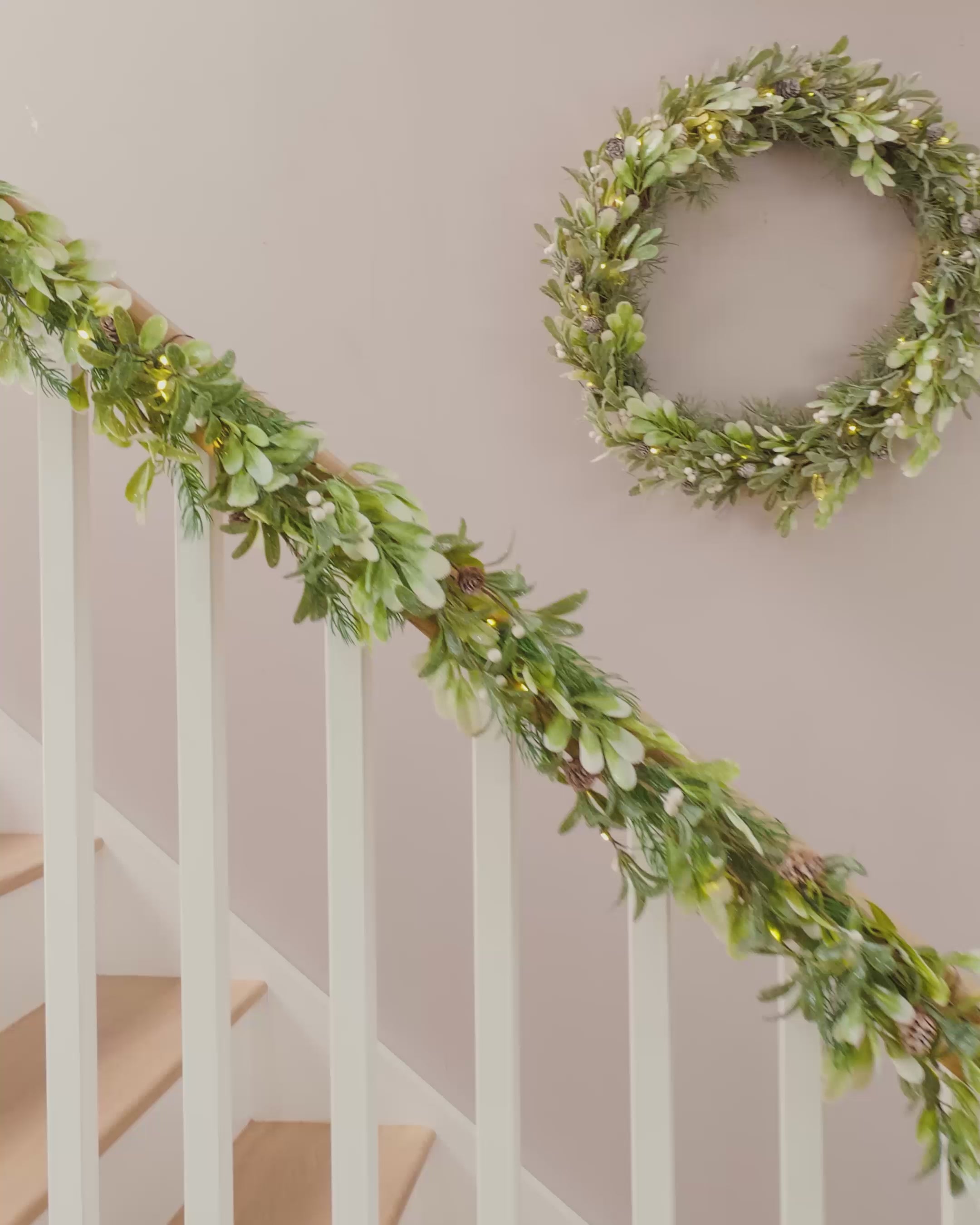 Load video: Pre-Lit Frosted Mistletoe Garland with Pinecones & Berries, 9 ft
