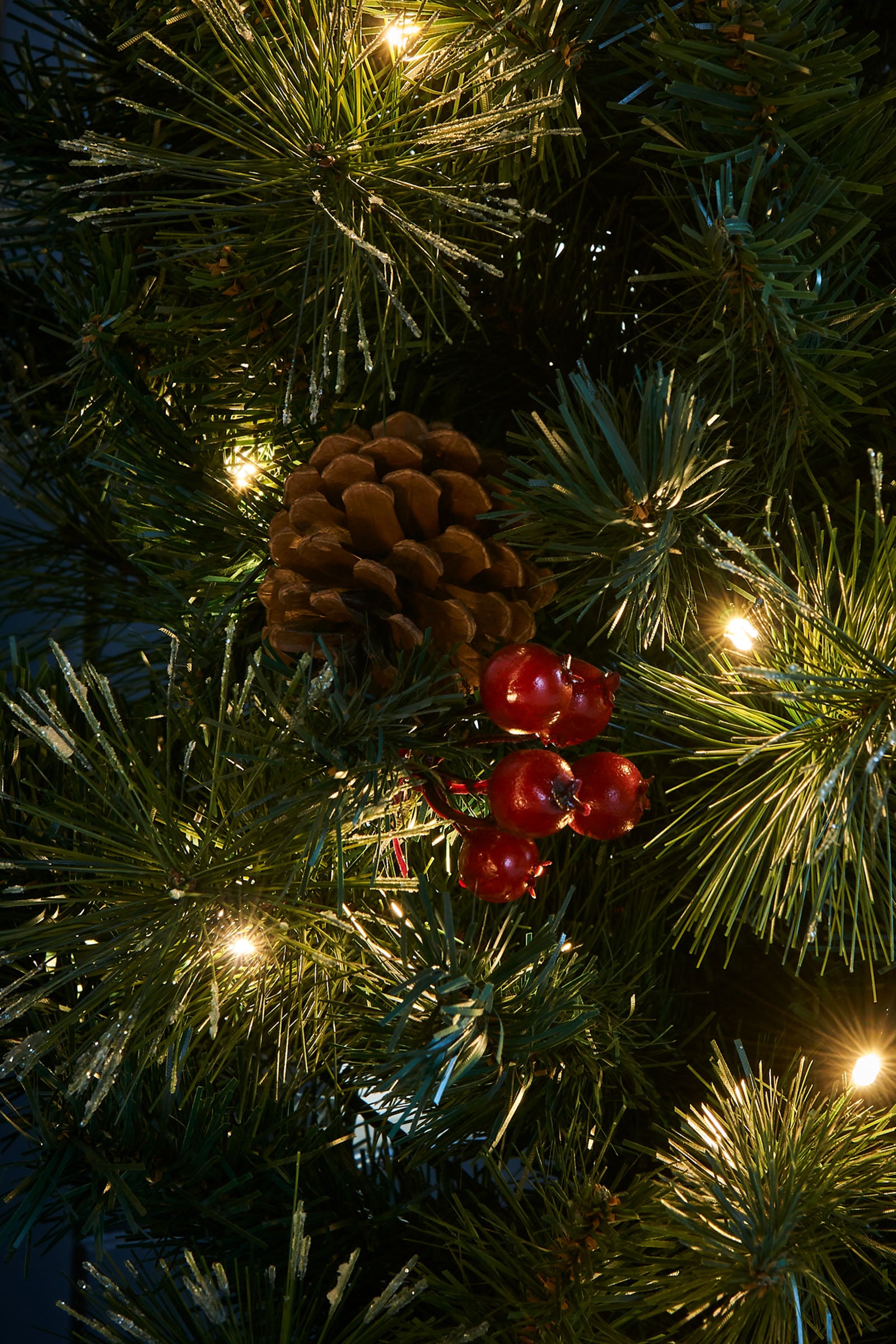 Pre-lit Christmas decoration set including two potted trees, a wreath, and a garland—all featuring warm white LED lights, red cluster berries, pinecones, and frosted PVC tips—ideal for creating a coordinated festive display at a home entrance.