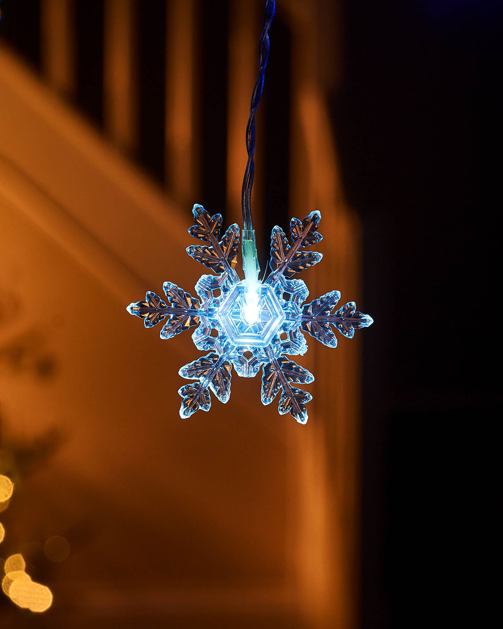 Close-up of a white LED snowflake light with clear snowflake detail