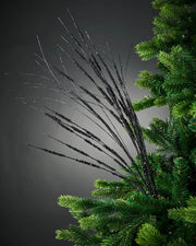 100cm black glitter wispy tree spray attached to tree in front of grey background