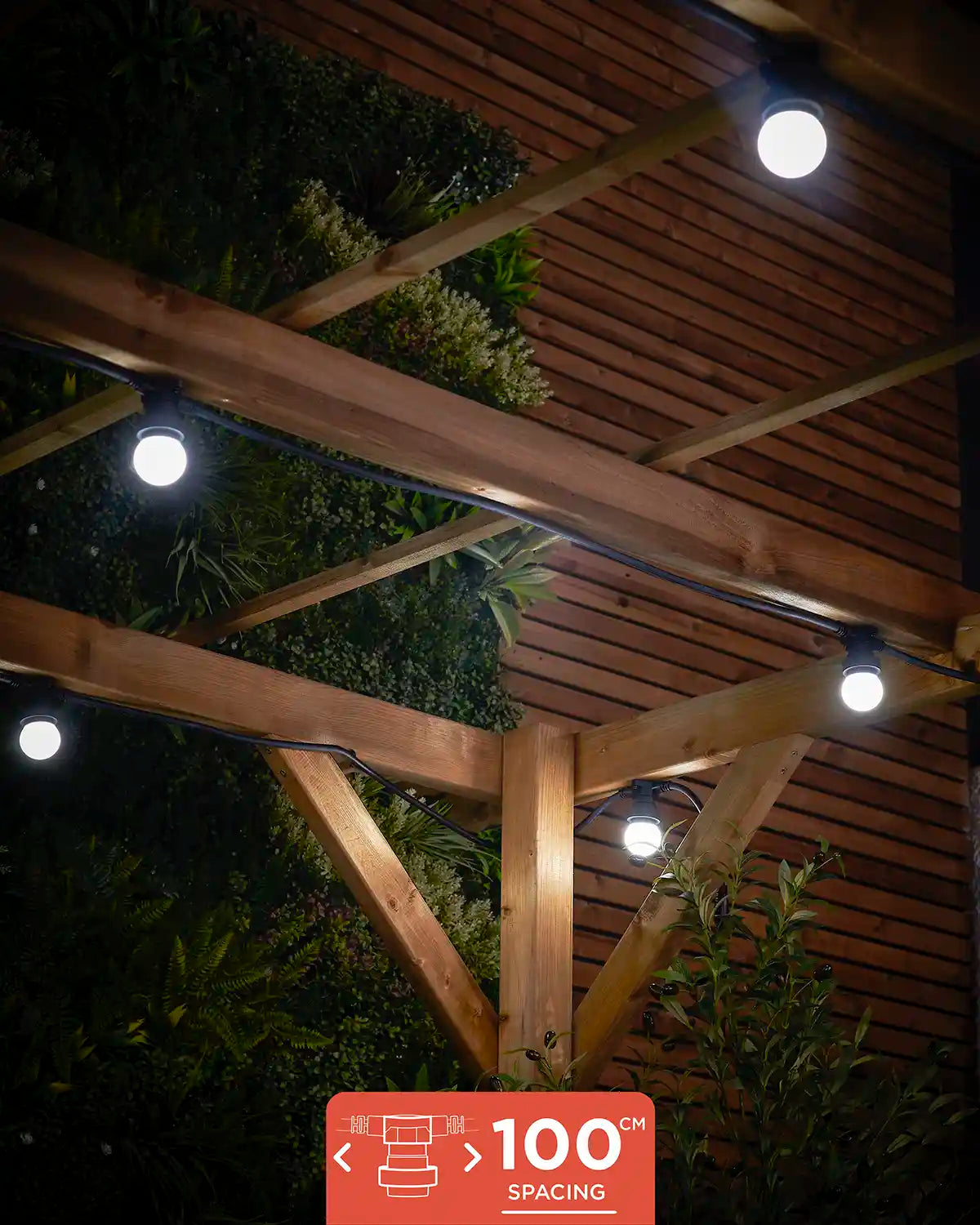 E27 festoon belt with 100cm socket spacing shown lit in white under a wooden pergola.