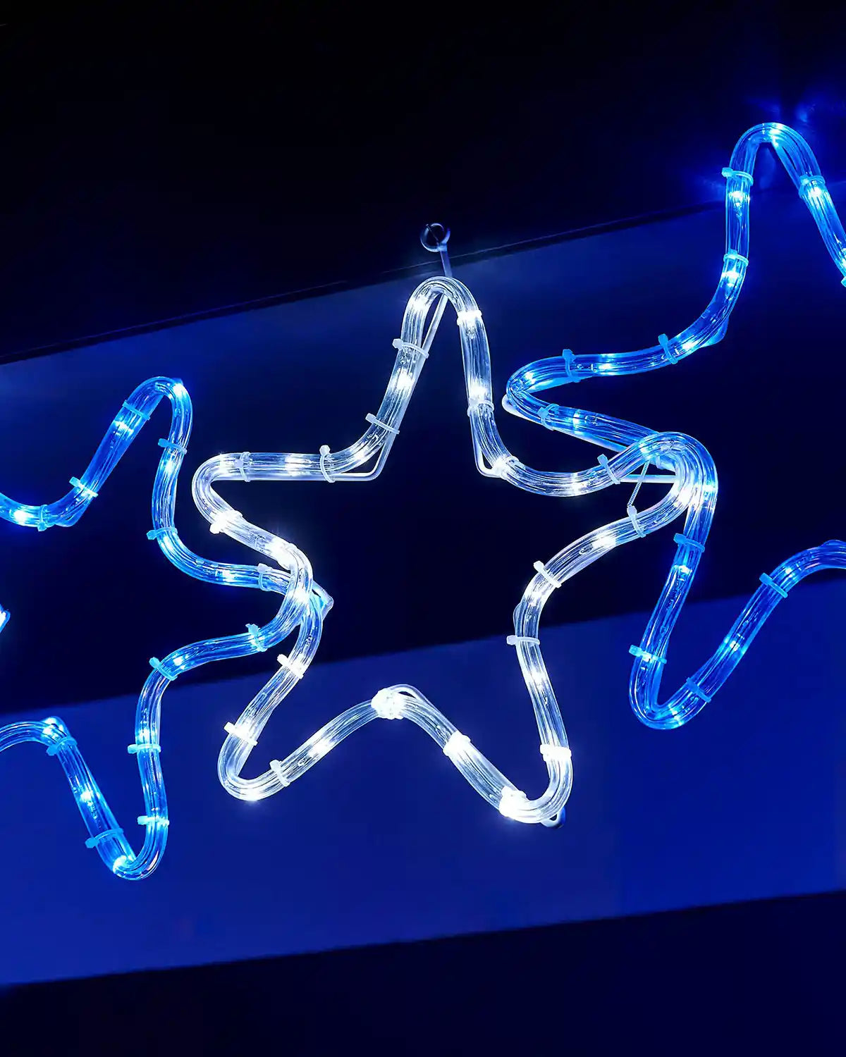 Close-up of a white and blue LED star on the 7-star rope light silhouette