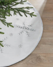 Close-up of a white 122 cm Christmas tree skirt with silver snowflake embroidery