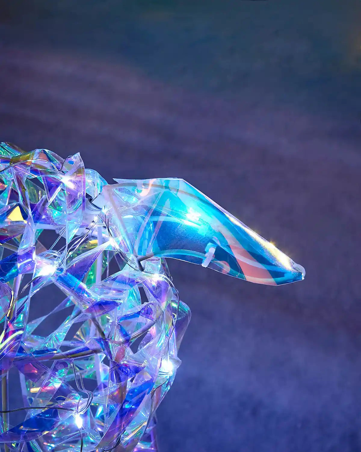 Close-up of the iridescent reindeer ear with blue-toned finish and cool white lights.