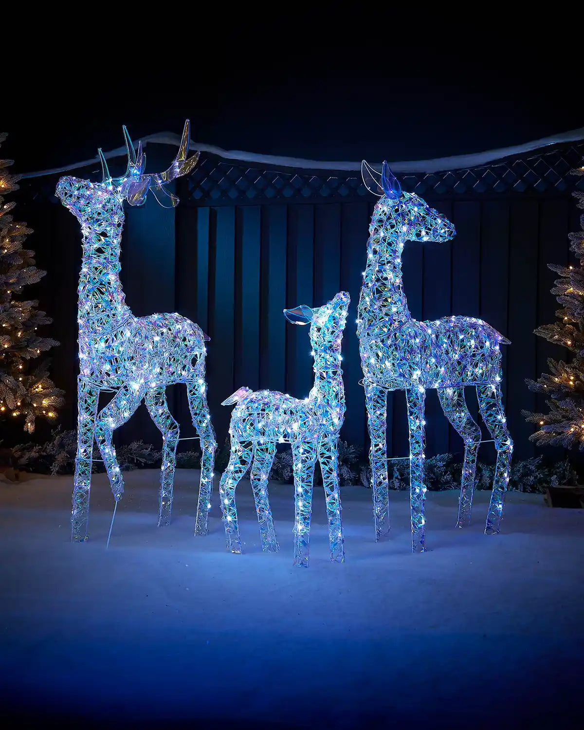 125cm pre-lit iridescent reindeer family with cool white LEDs in an outdoor festive display.