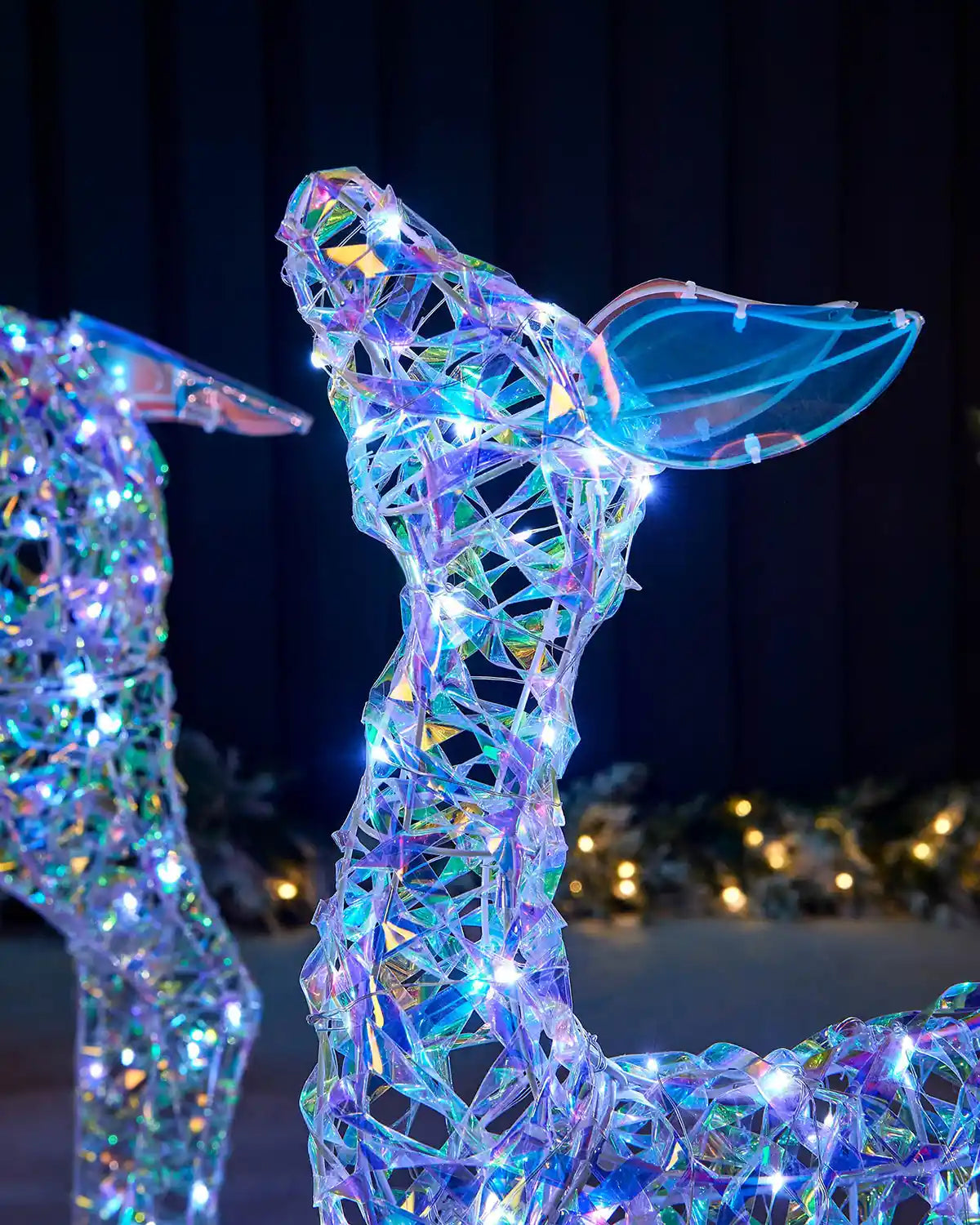 Close-up of the smaller iridescent reindeer head with clear ears, woven frame and bright LEDs.
