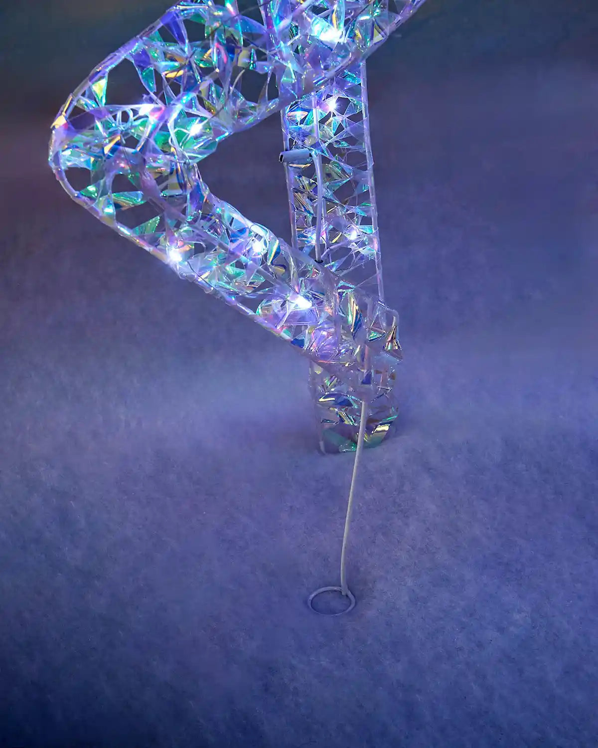 Detail of the iridescent reindeer leg with ground stake for securing the outdoor display.