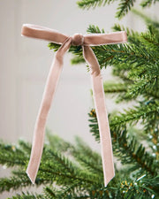 Close-up of a 13cm mocha velvet bow tied to a Christmas tree branch