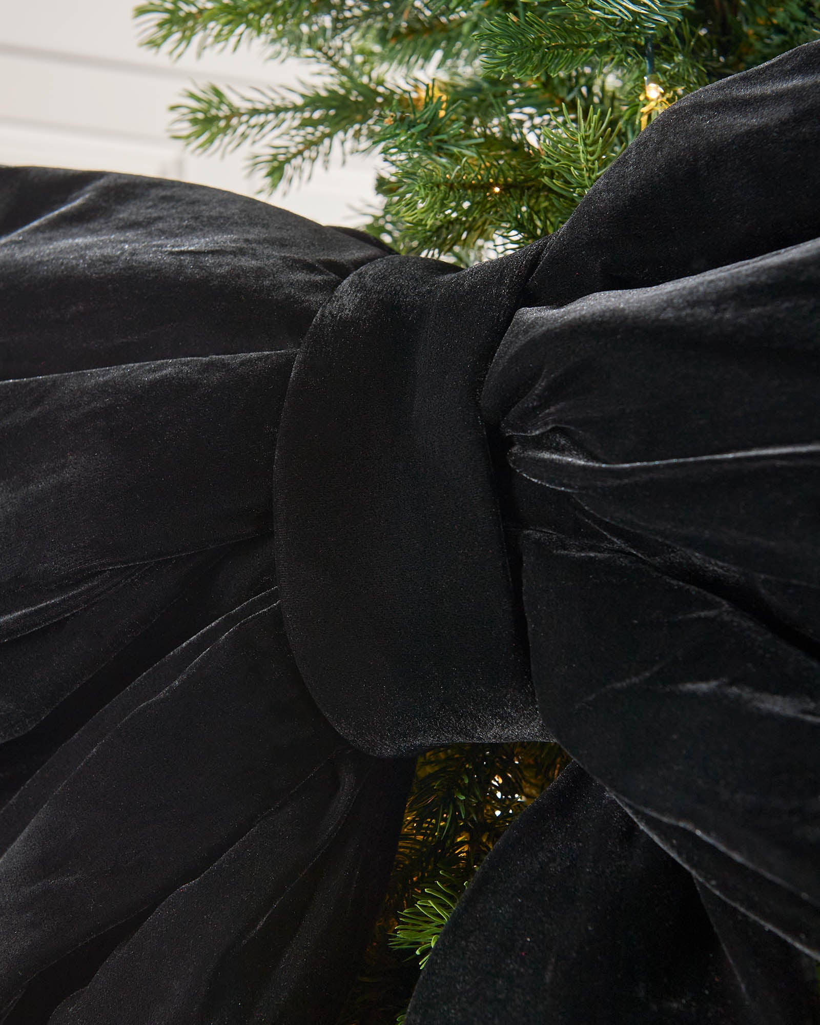 Detail close-up of the centre of a large black velvet Christmas bow