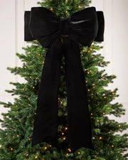 Large 140cm black velvet Christmas bow displayed on a lit Christmas tree