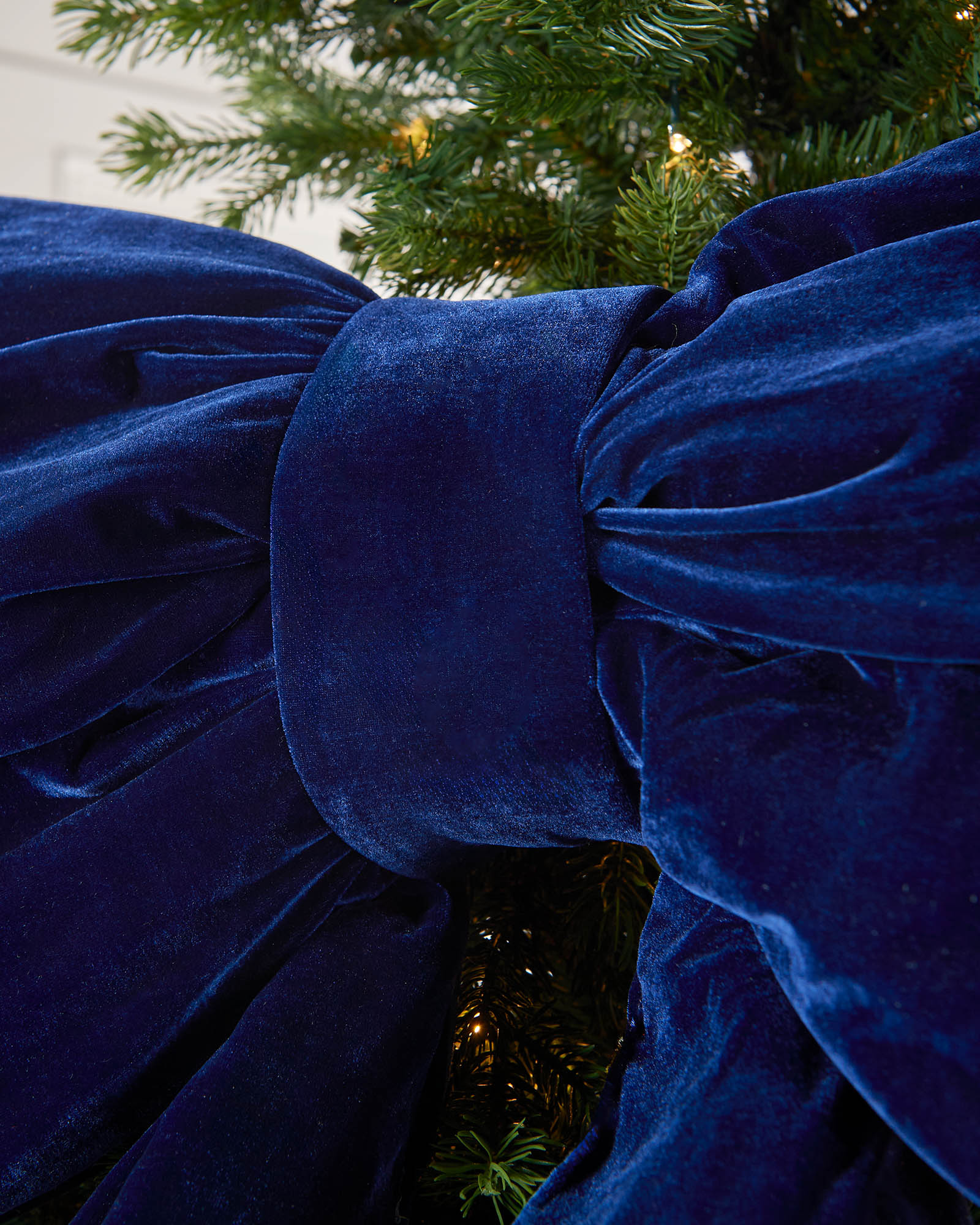 Detail close-up of the centre of a large navy velvet Christmas bow