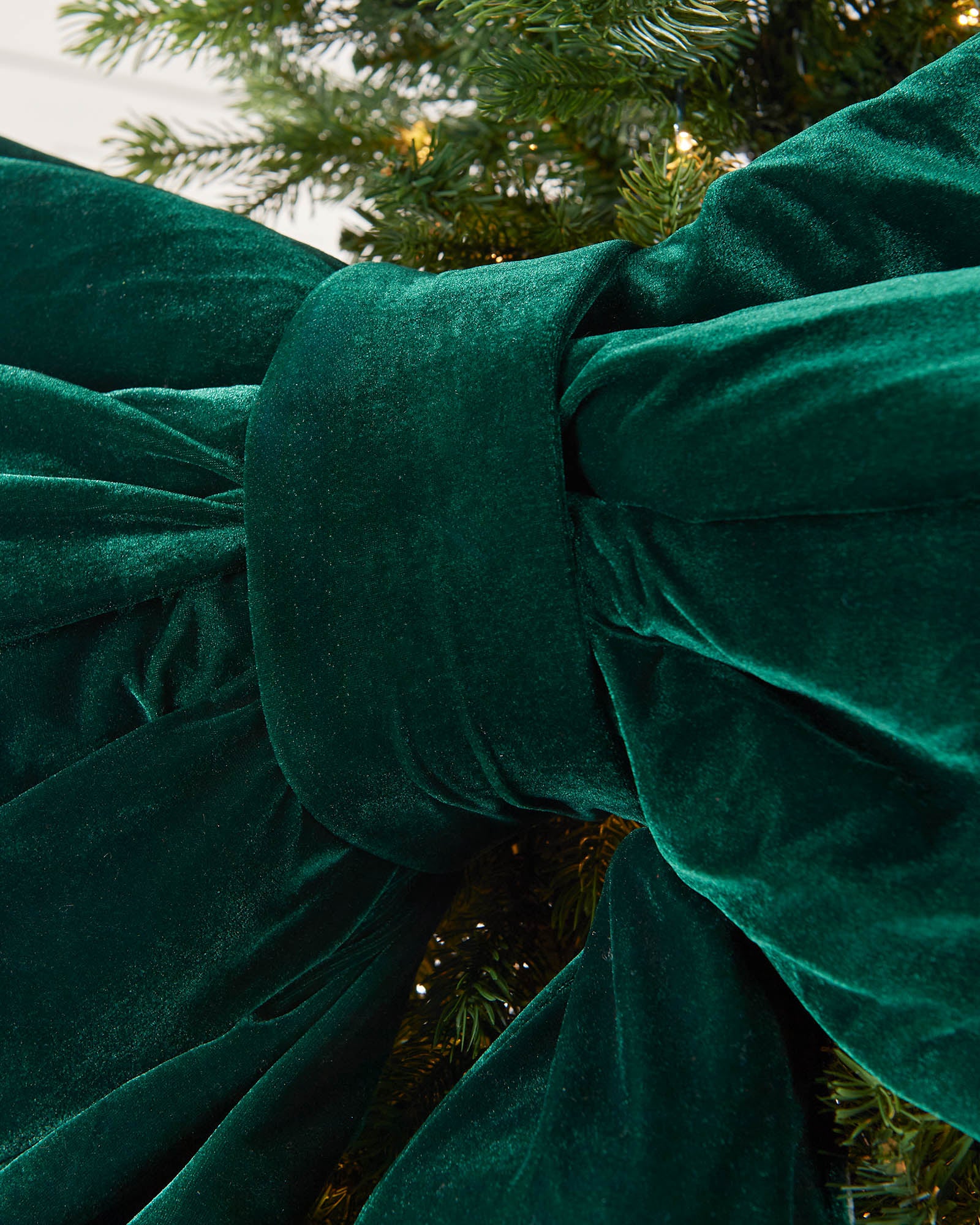Detail close-up of the centre of a large sage green velvet Christmas bow