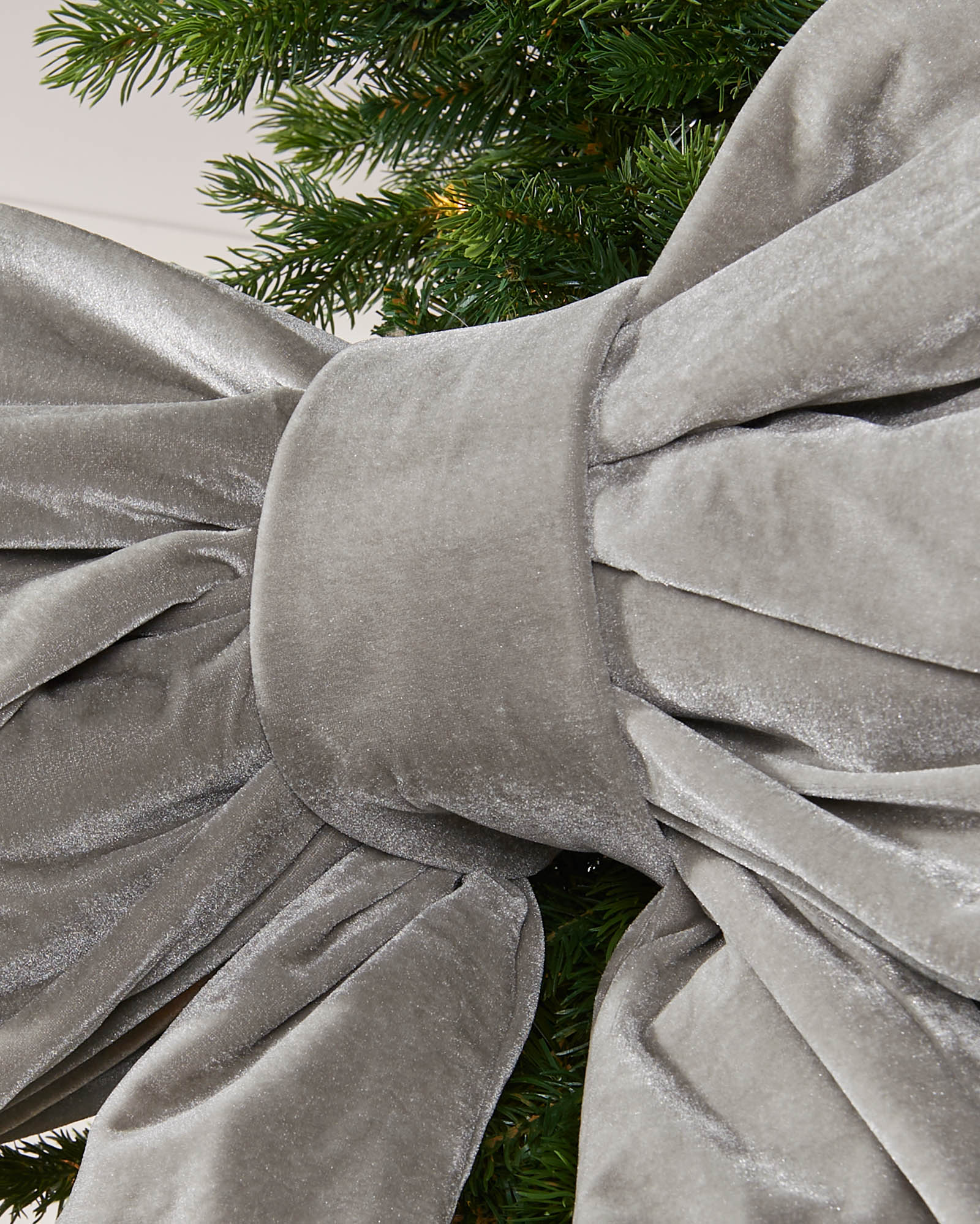 Detail close-up of the centre of a large silver velvet Christmas bow