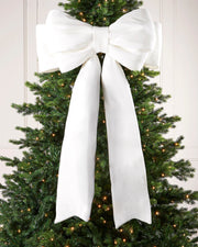 Large 140cm white velvet Christmas bow displayed on a lit Christmas tree