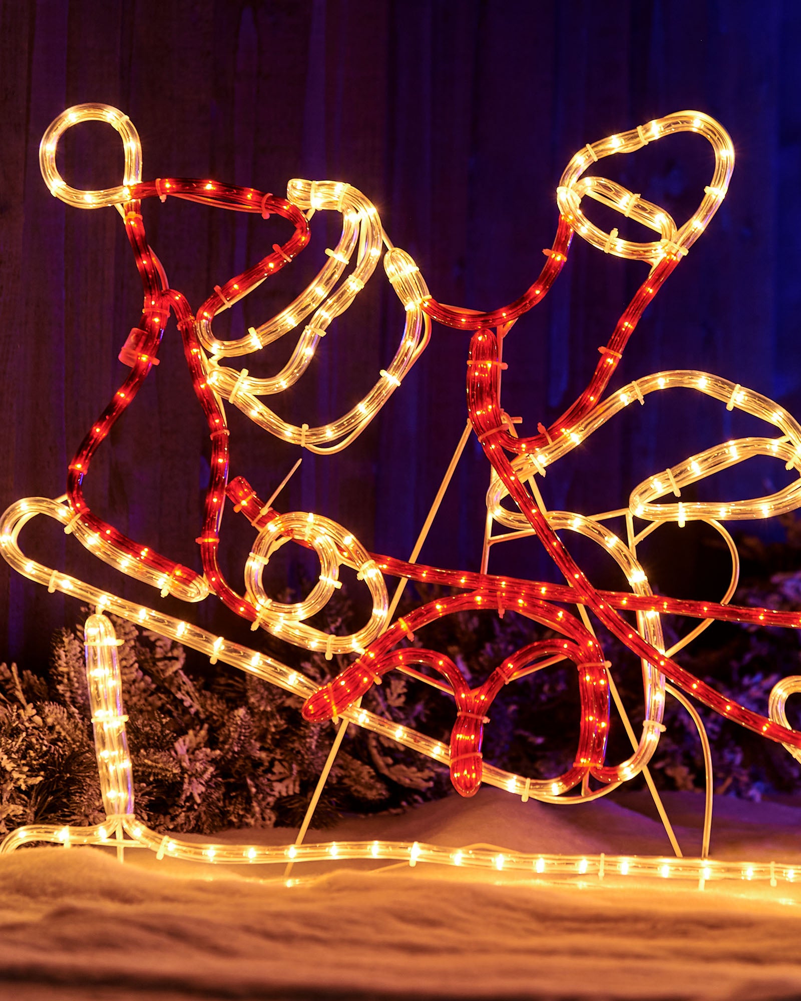 Close-up of Santa in a sleigh rope light silhouette with warm white and red LEDs
