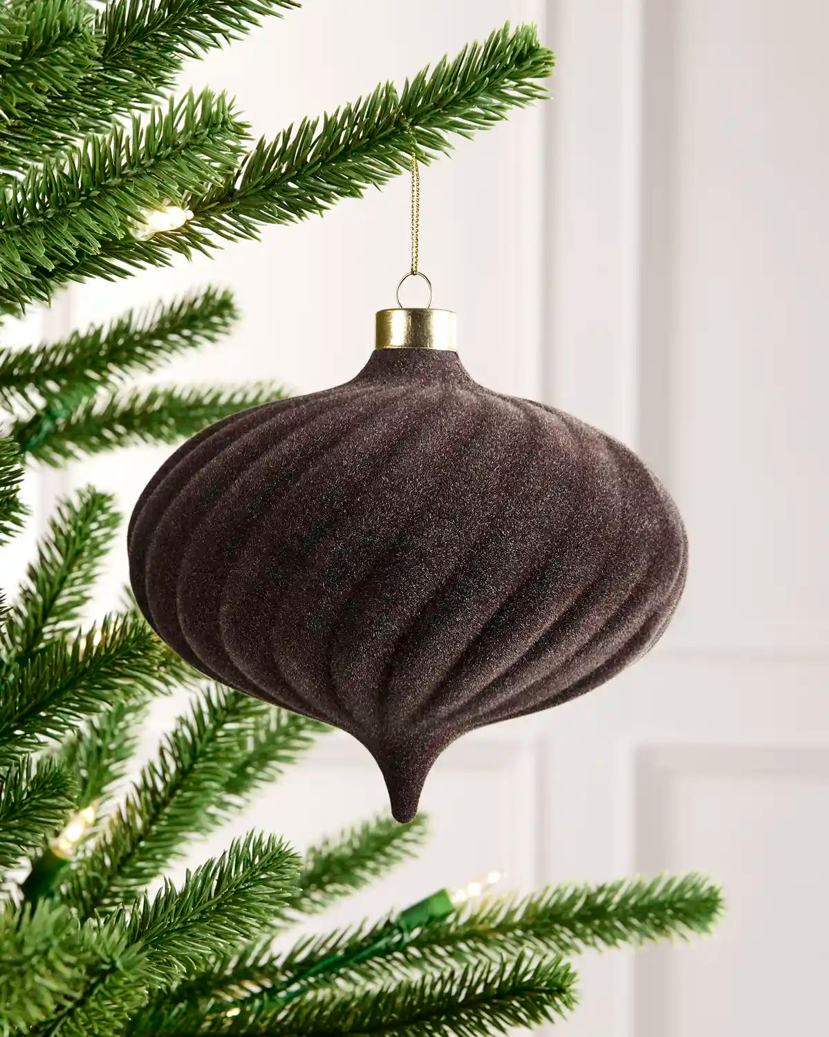 15 cm Espresso oversized velvet Spiral bauble hanging from a Christmas tree with a gold cap.

