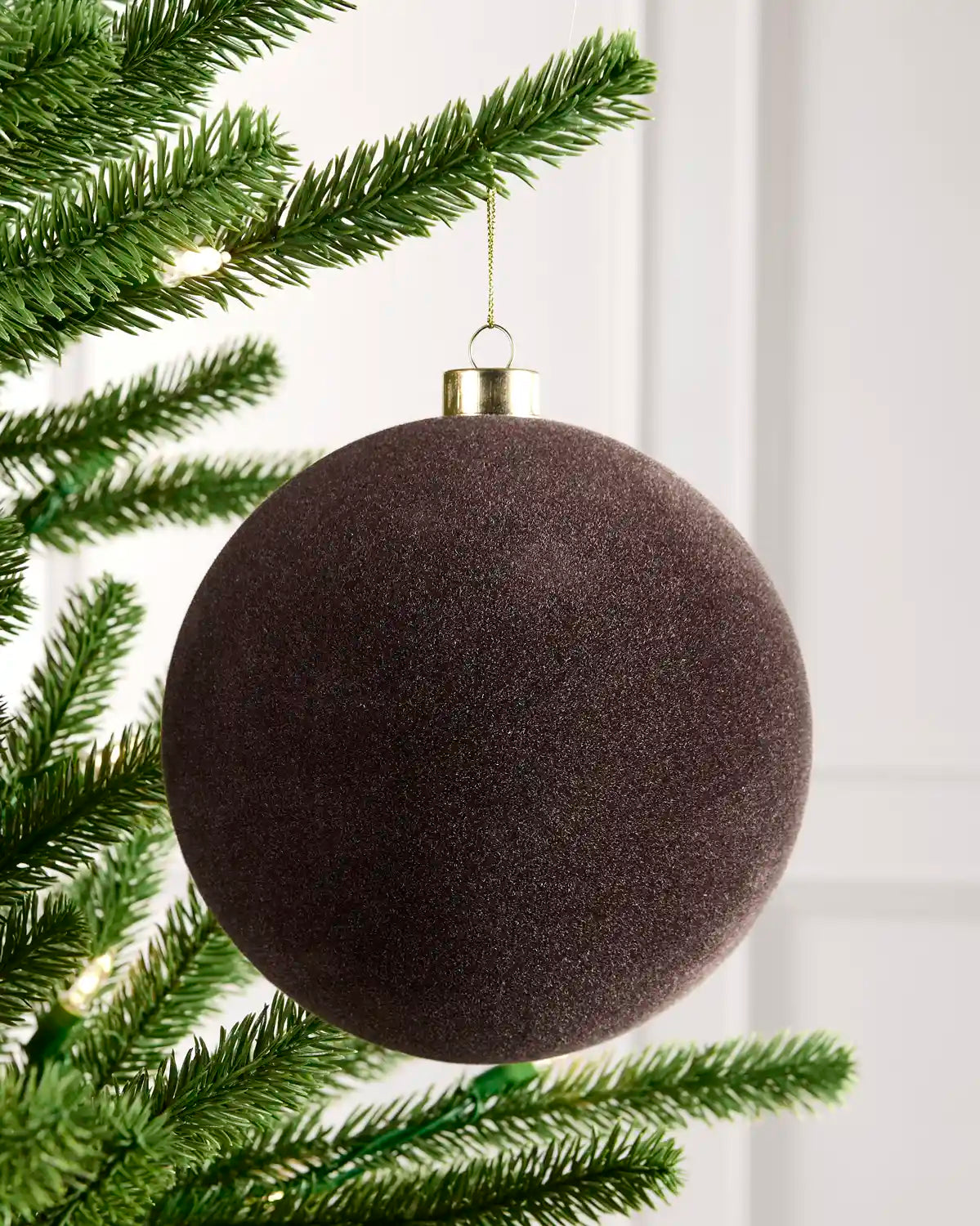 15 cm Espresso oversized velvet Traditional bauble hanging from a Christmas tree with a gold cap.
