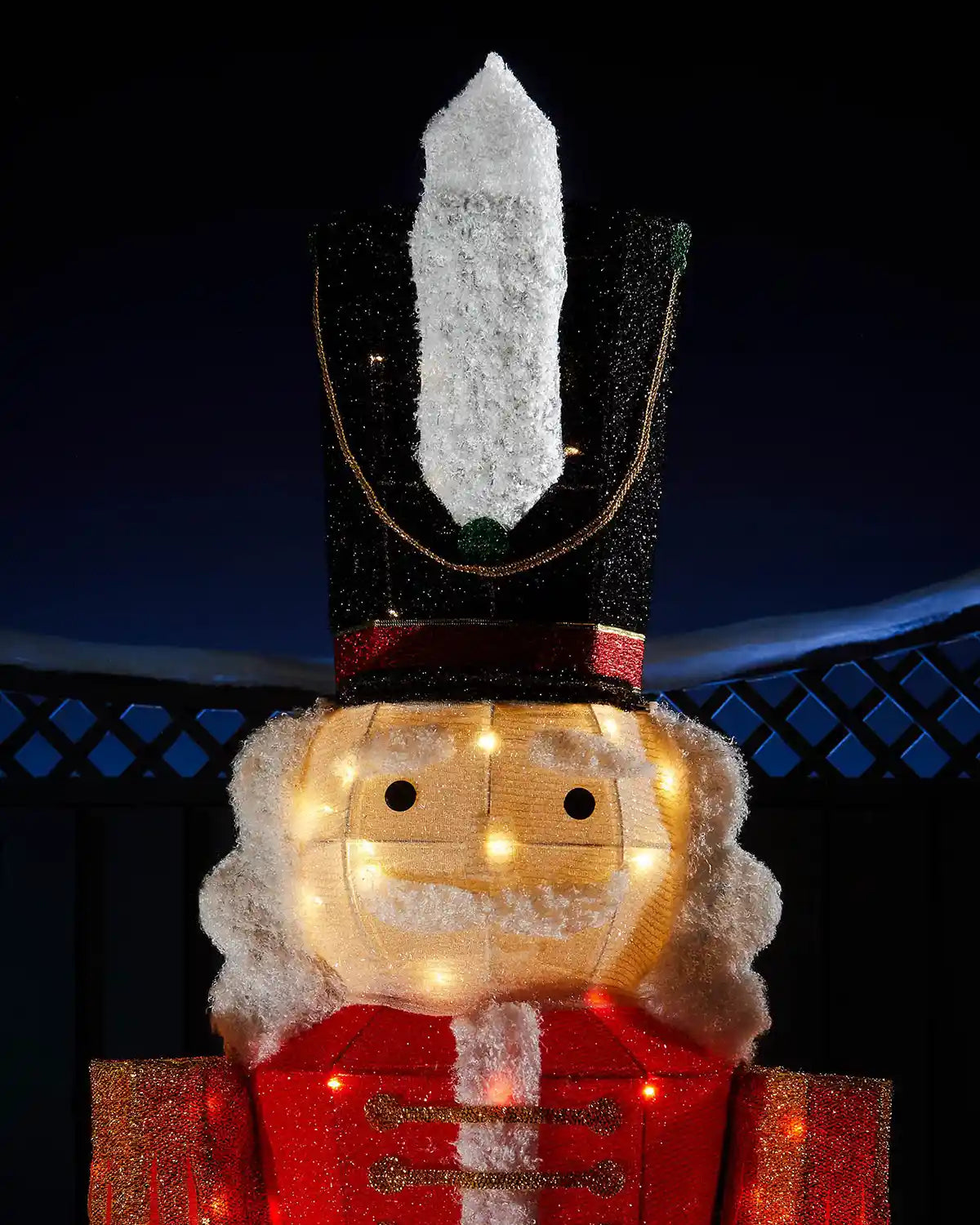 Close-up of the 165cm pre-lit nutcracker face and tall black hat with warm white lights.
