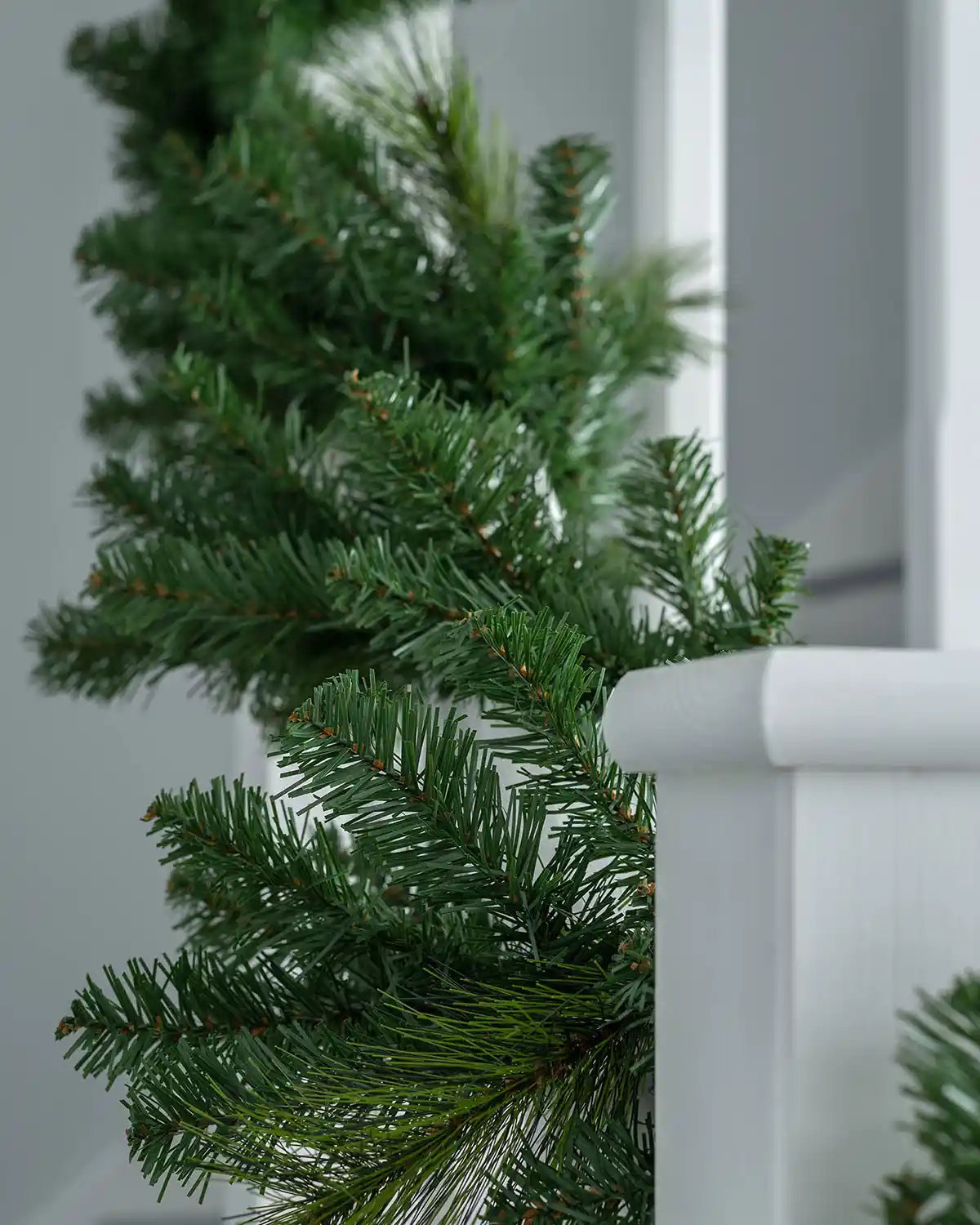 Close-up of plain Christmas garland foliage on a staircase banister