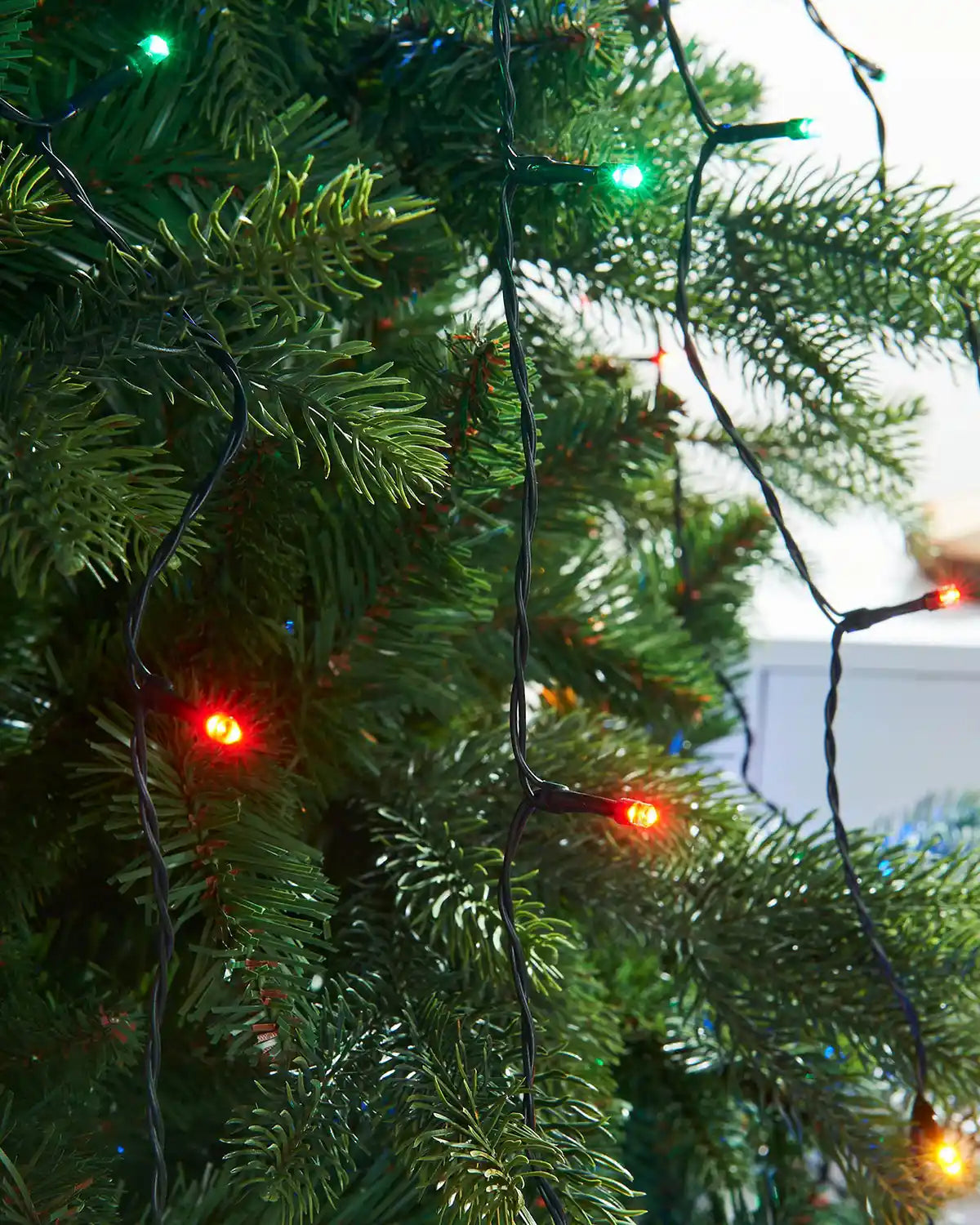 Close up on multi coloured single lit bulbs on 192 LED Christmas Tree String Lights, Multi Colour, 2 m