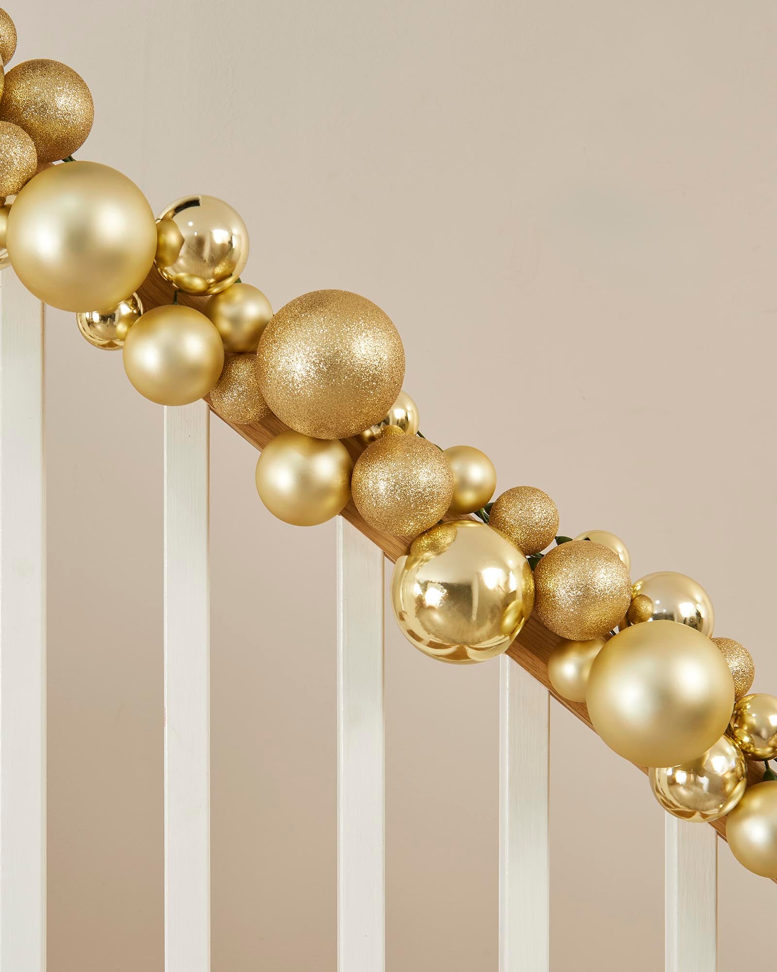 Decorative gold ball arch against a neutral background
