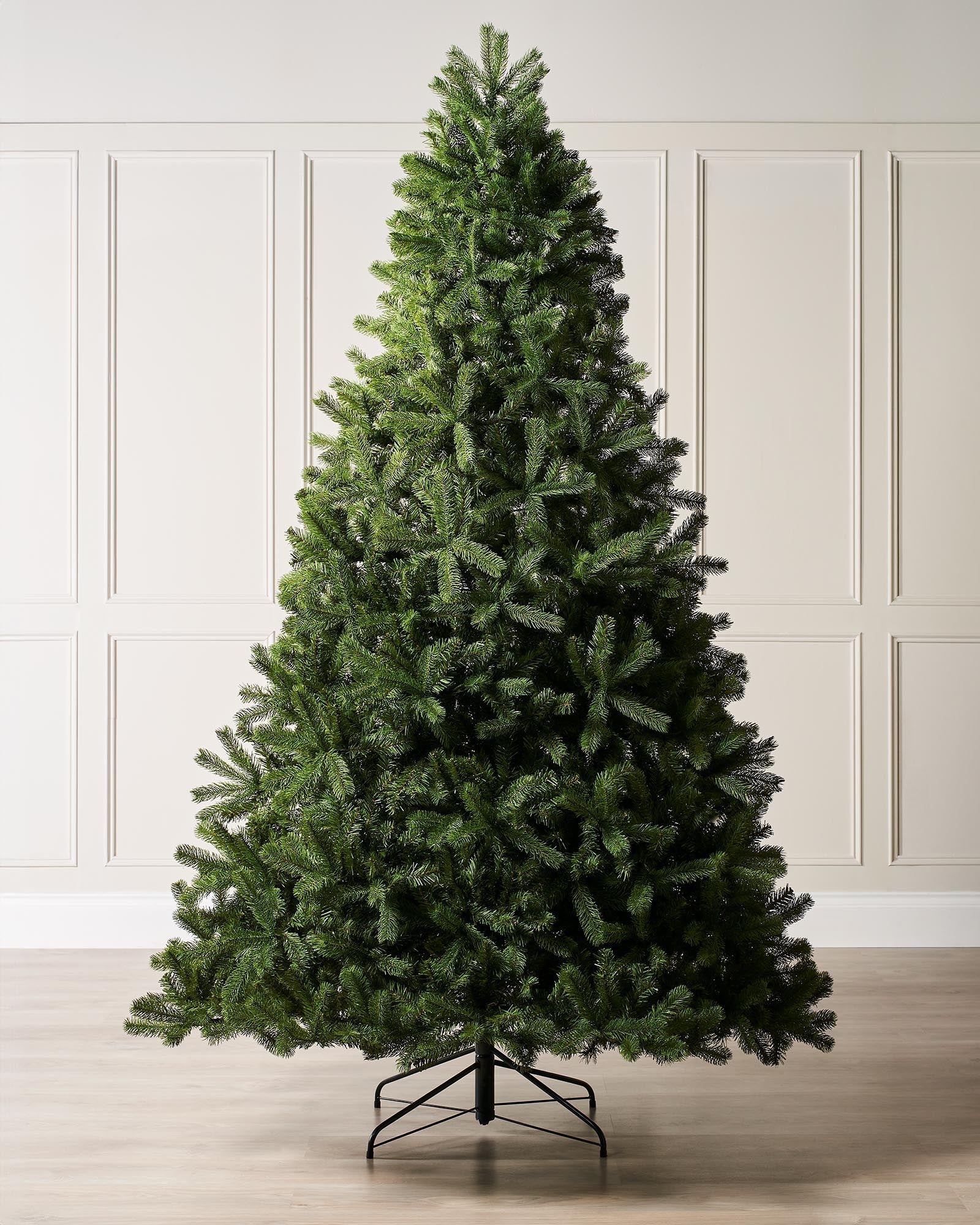 A 8-foot tall mixed pine artificial Christmas tree with a foldable black metal base.