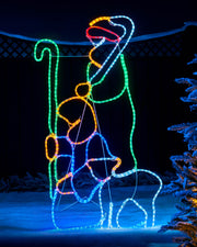 Colorful LED light display of a bear and cub in a snowy landscape