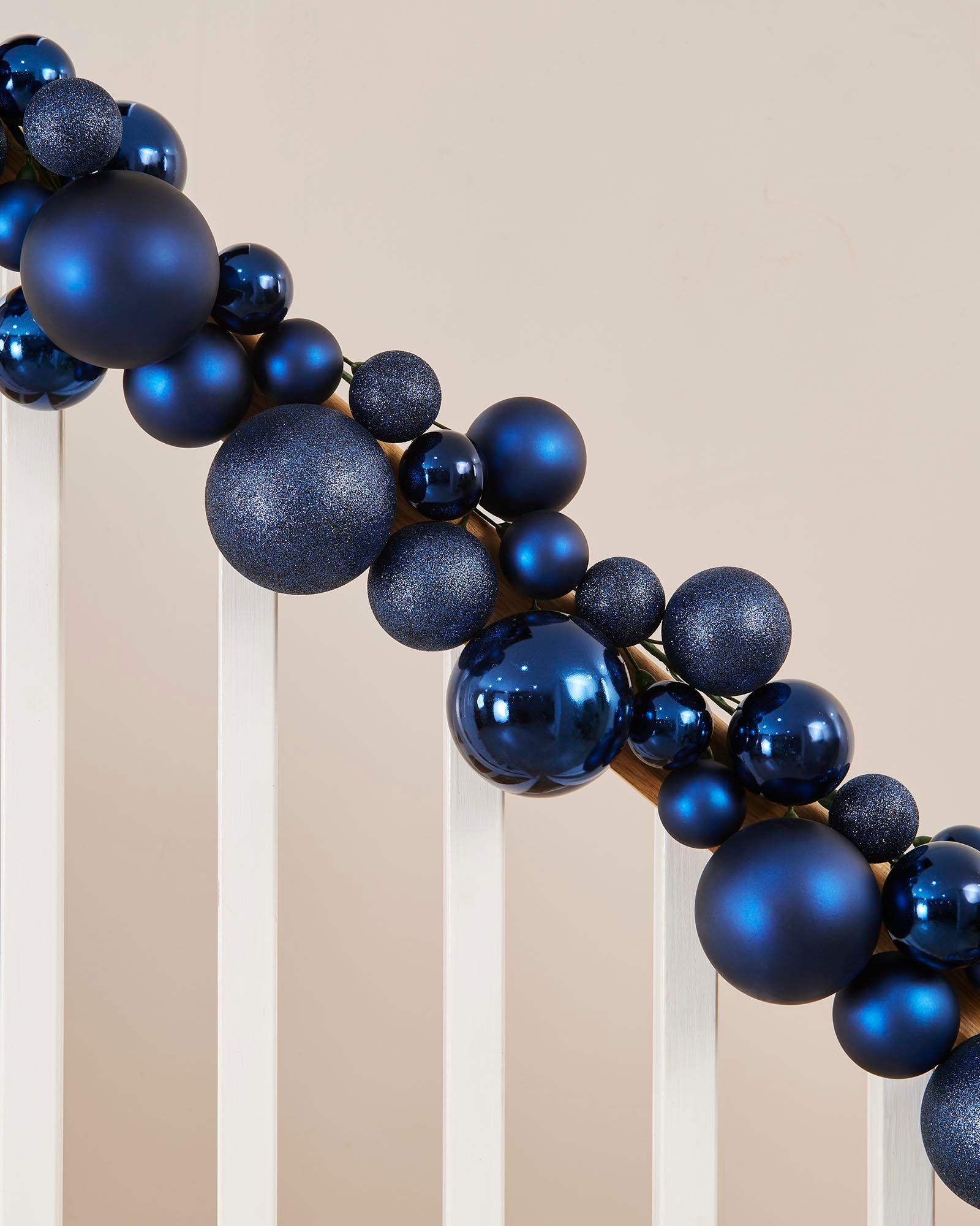Decorative wreath made of blue spherical ornaments on a neutral background