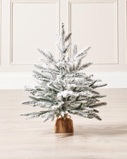 A 2-foot tall artificial Christmas tree featuring 184 snow-flocked PE tips and a natural brown hessian-wrapped base. Compact and elegant, perfect for smaller spaces and festive decorating with a rustic, wintry charm.