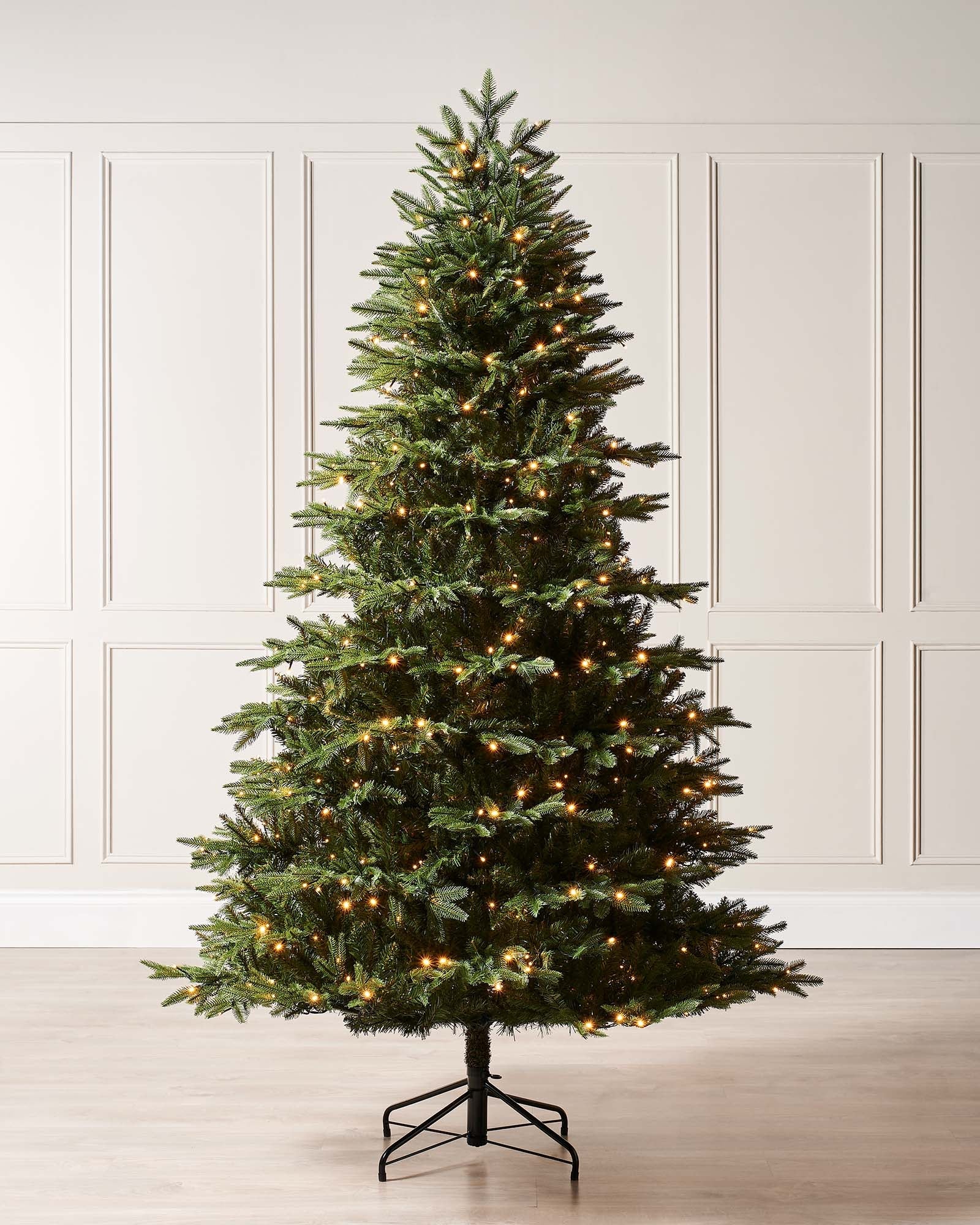 A 4 ft pre-lit potted pine and Royal Fir Christmas tree duo, both with lush green foliage. One stands in a decorative pot with dual warm white and multicolour LED lights for indoor or outdoor use; the other features multi-function warm white LED lights on a metal stand, displayed against a white background.