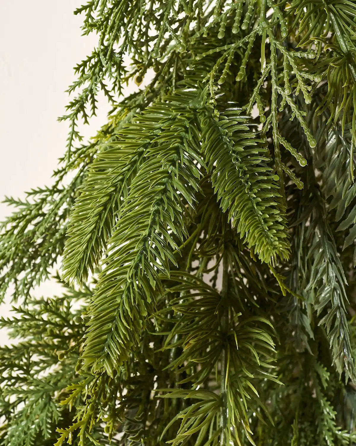 Detailed close-up of realistic PE tips on 1 m natural fir wreath