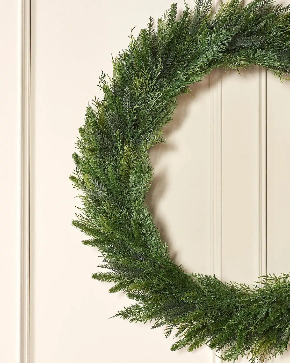 Close-up of 1 m natural fir wreath on a lifestyle wall