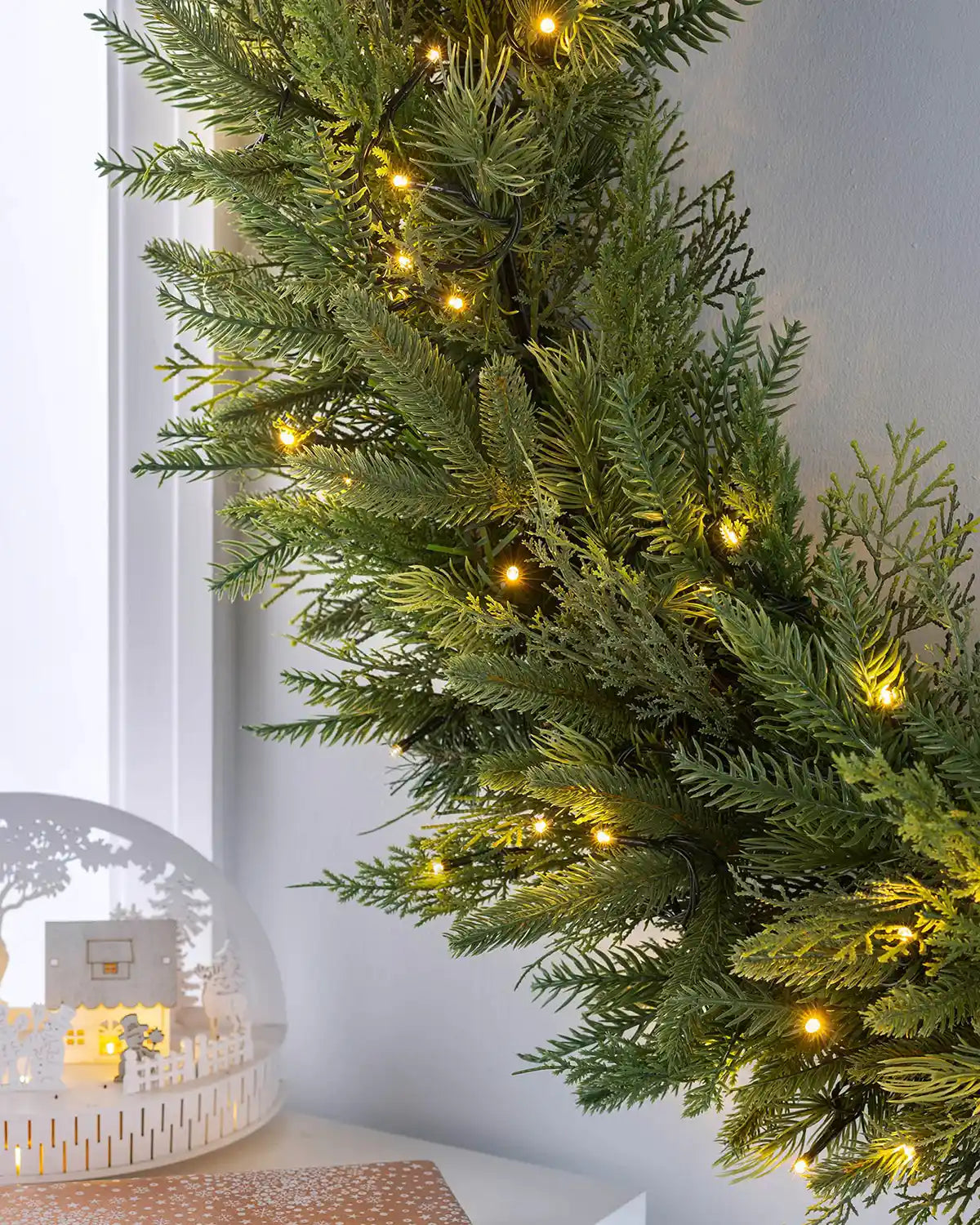 Close-up of 1 m pre-lit fir wreath foliage with warm white LEDs