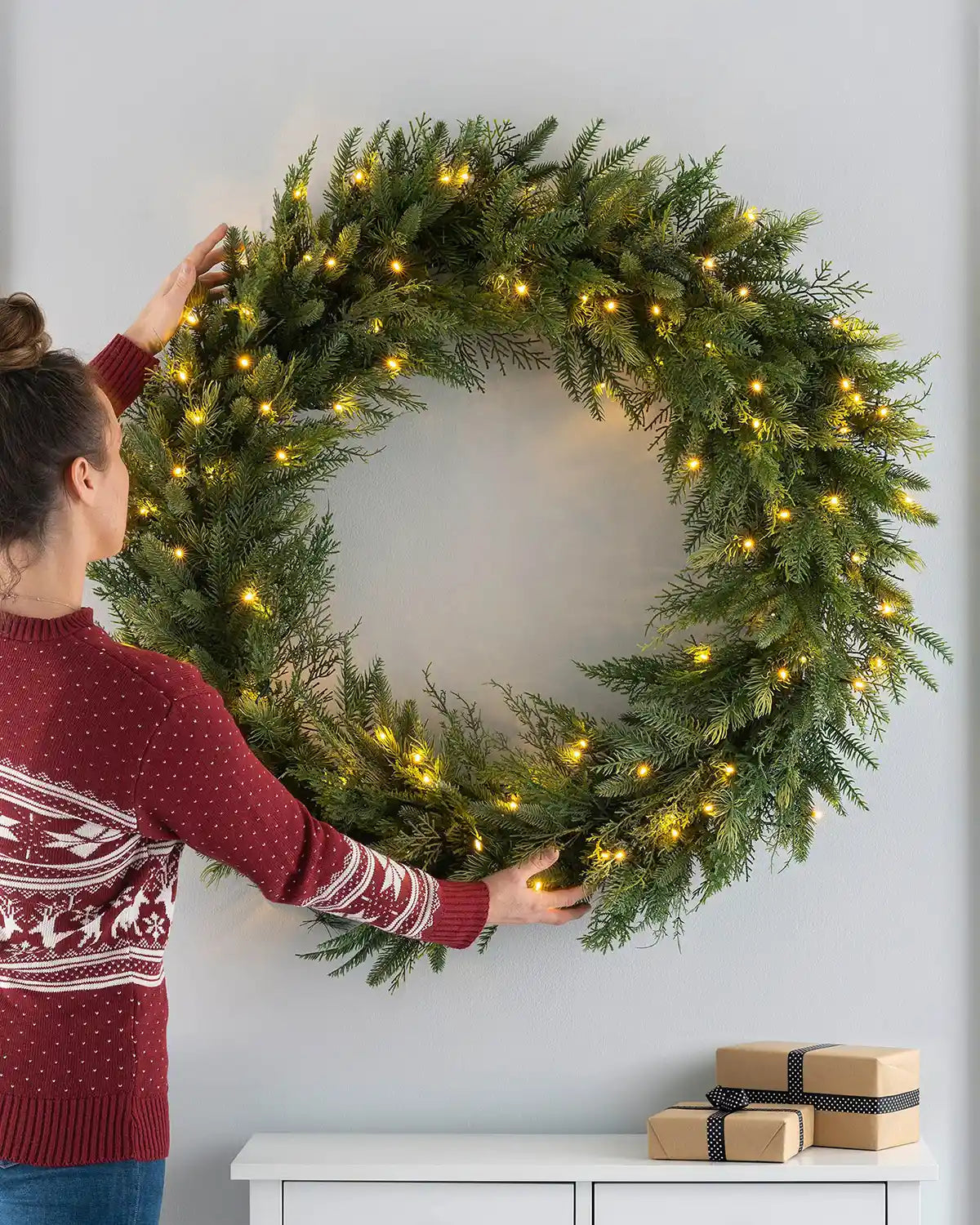 Full 1 m pre-lit fir wreath placed on a lifestyle wall