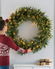 Full 1 m pre-lit fir wreath placed on a lifestyle wall